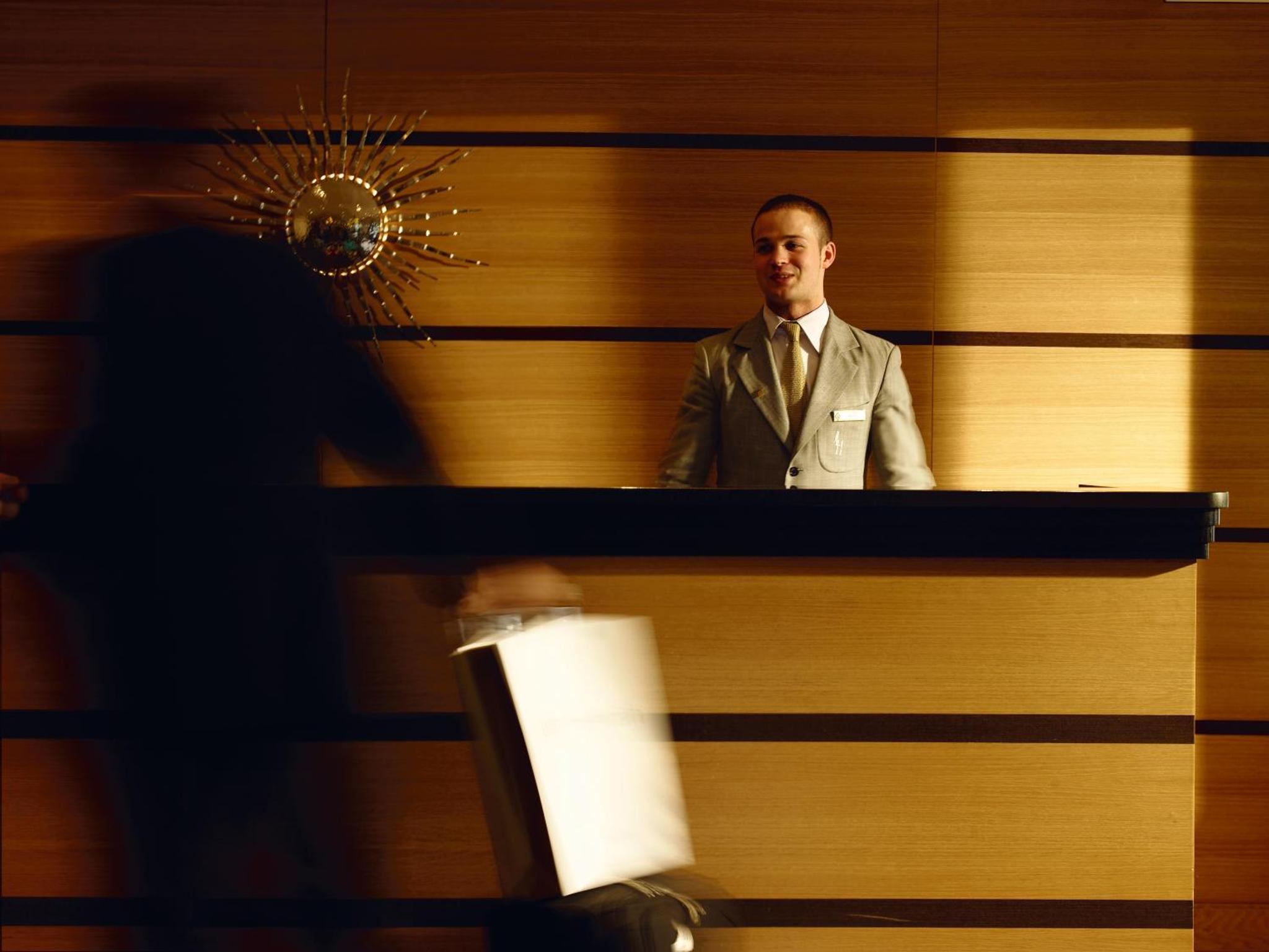 a man in a suit standing at a podium at The Lowndes London - A Jumeirah Partner Hotel in London +19 photos