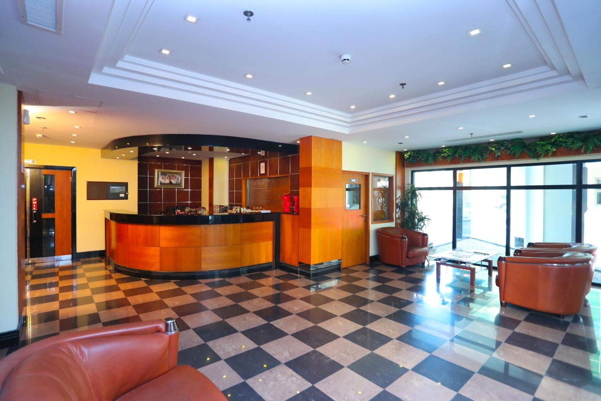 a lobby with a bar in a building at One Pavilion Luxury Serviced Apartments in Manama +33 photos