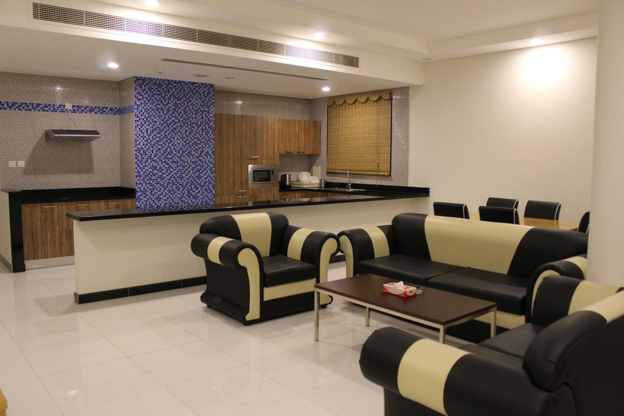 a waiting room with couches and a bar at Asian Tower in Al Ghurayfah +24 photos