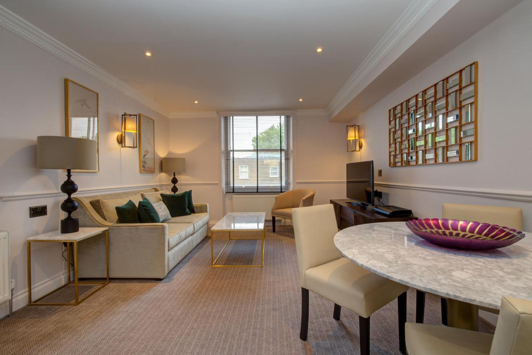 a living room with a couch and a table at Collingham Serviced Apartments in London