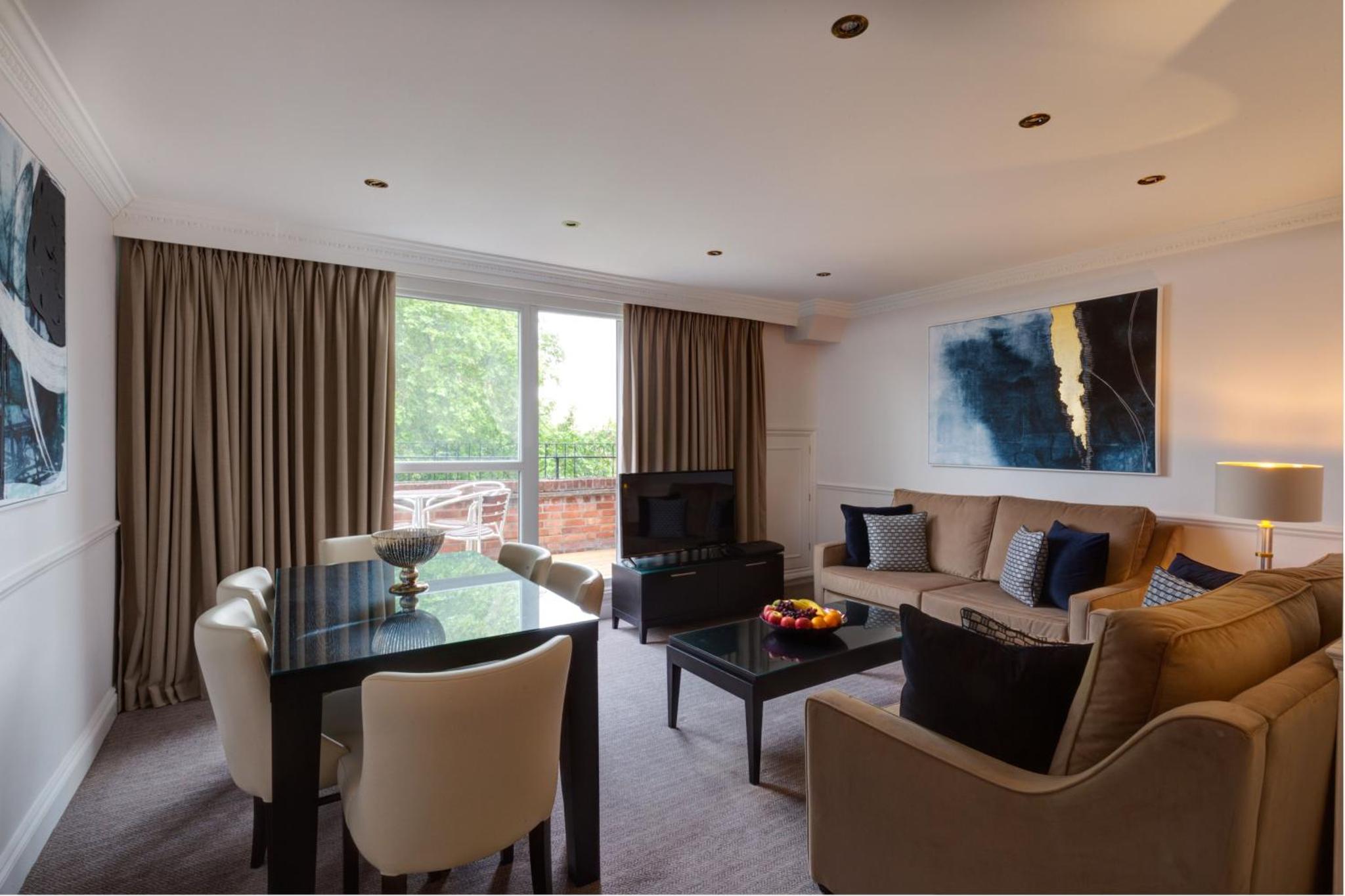 a living room with a couch and a table at Collingham Serviced Apartments in London