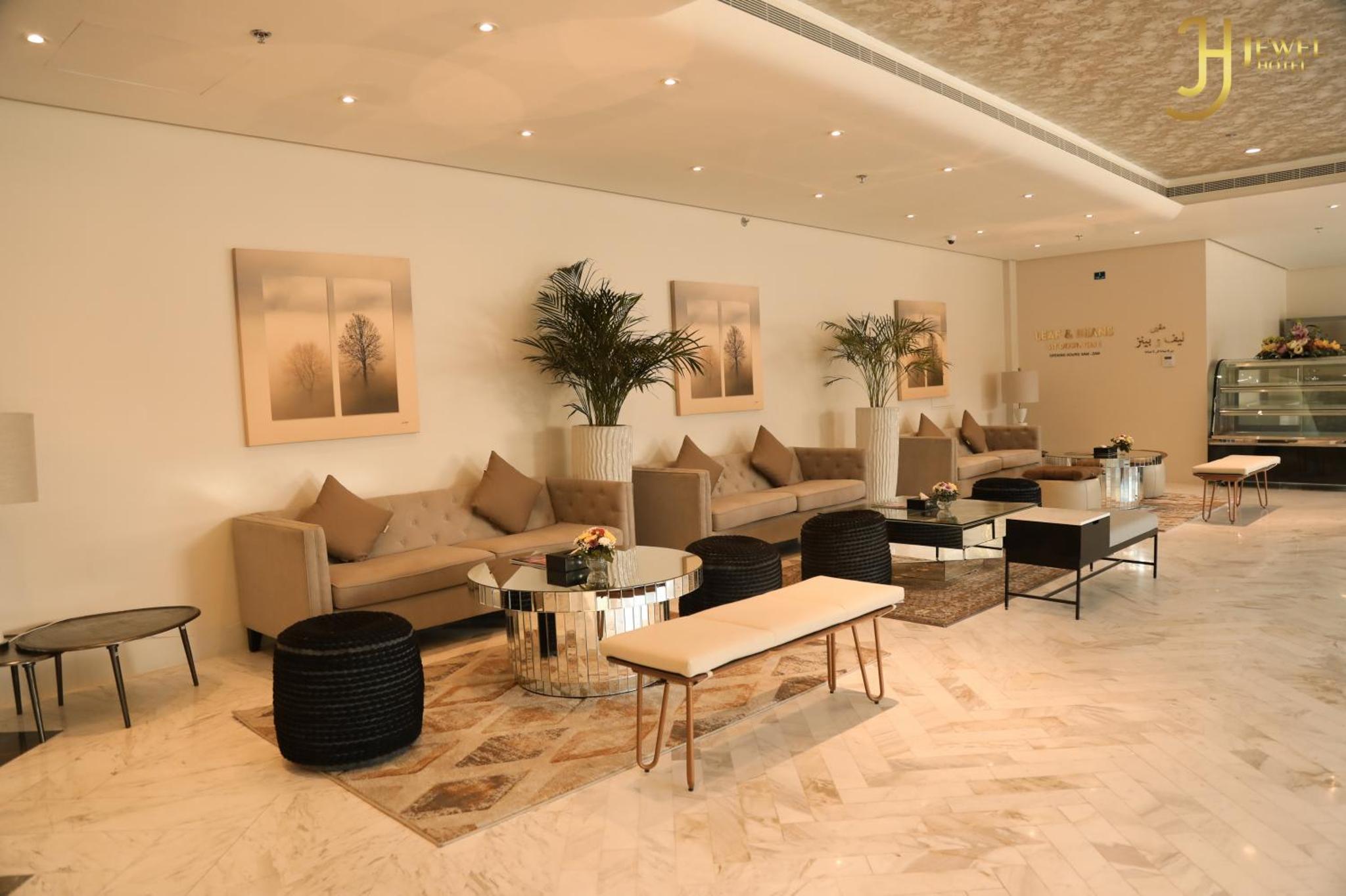 a lobby with couches and tables in a building at Sunday Luxury Downtown Adliya Formerly Jewel Hotel in Manama +100 photos