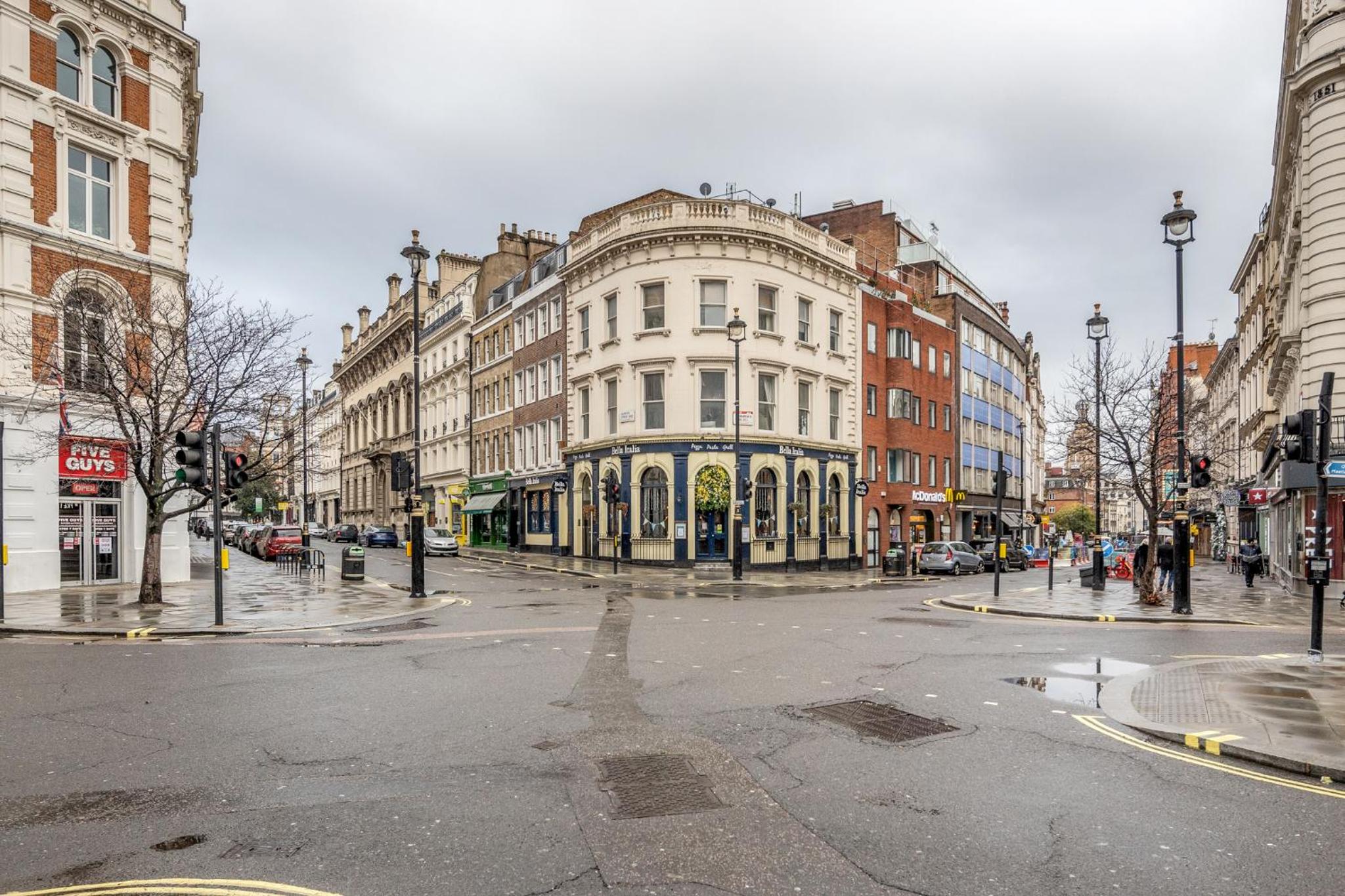 an empty street in a city with buildings at Stay Kula London - Covent Garden Garrick St in London
