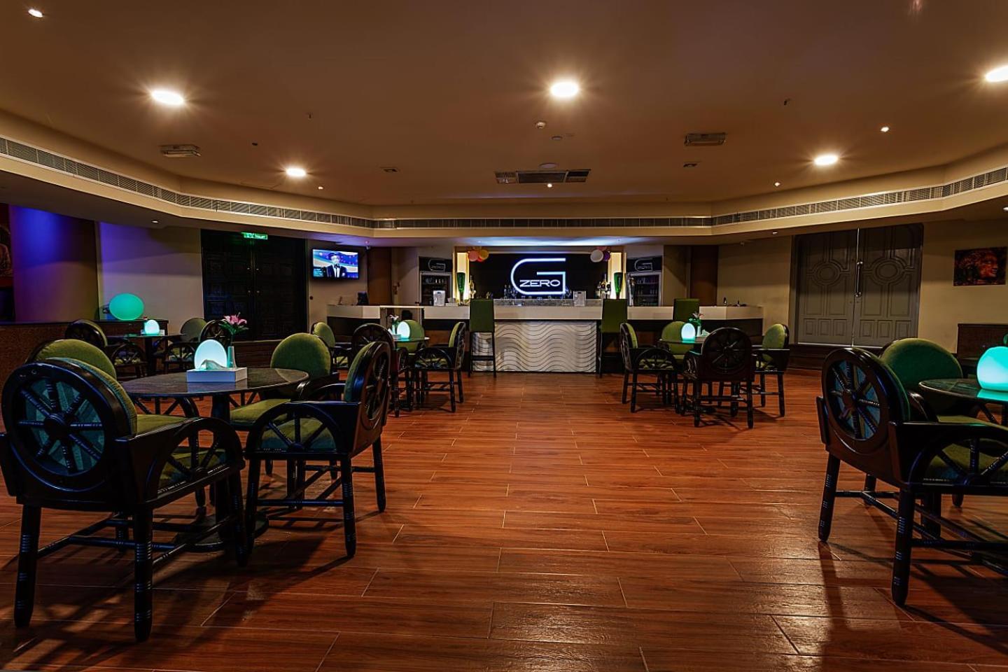 a restaurant with tables and chairs and a television at Phoenicia Tower Hotel And Spa in Manama +36 photos