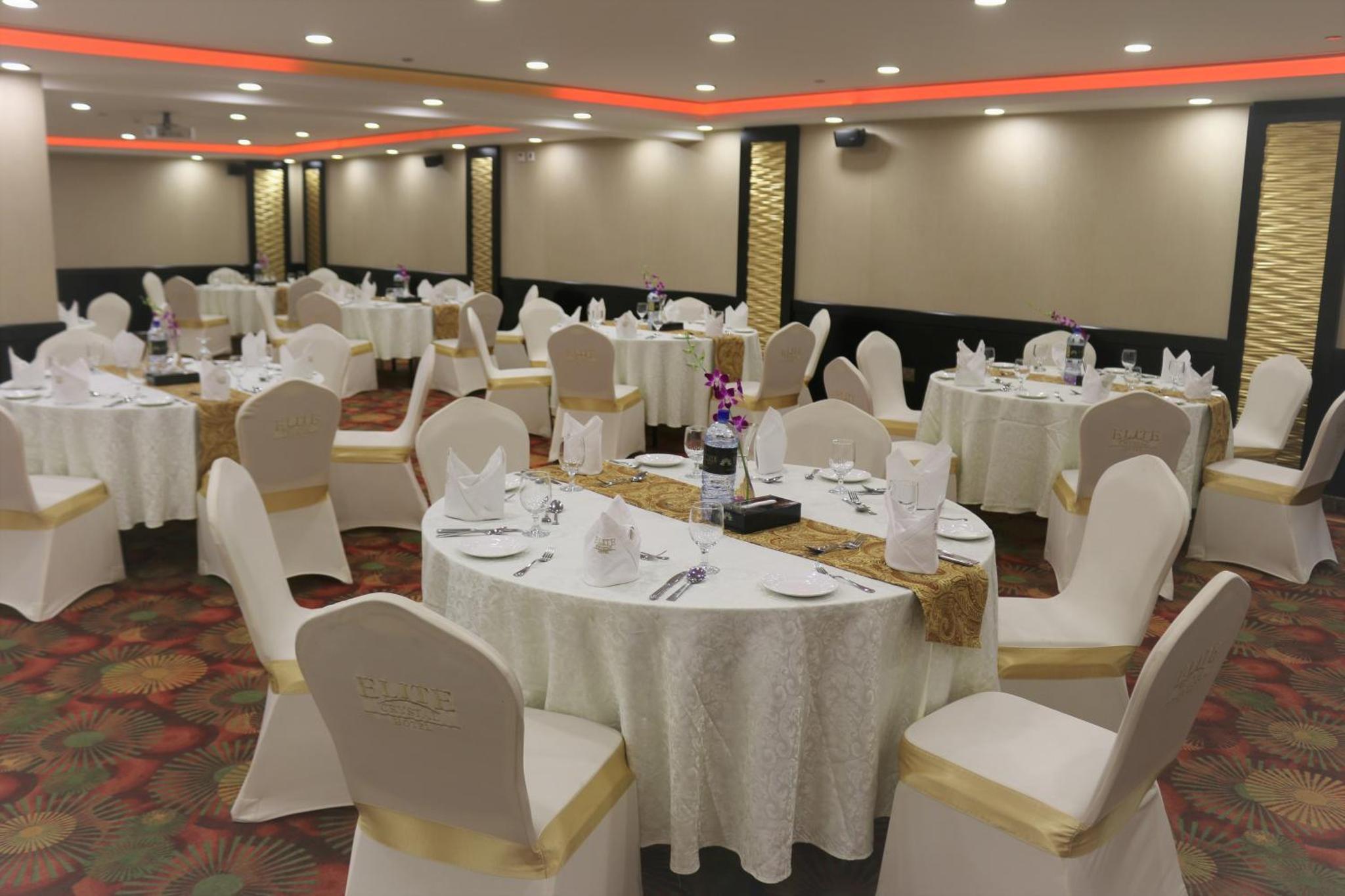 a banquet hall with white tables and chairs at Elite Crystal Hotel in Manama +32 photos