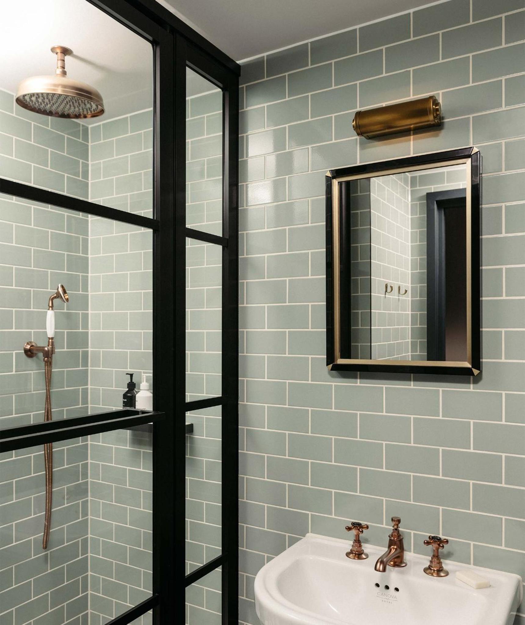 a bathroom with a sink and a mirror at The Hoxton, Southwark in London