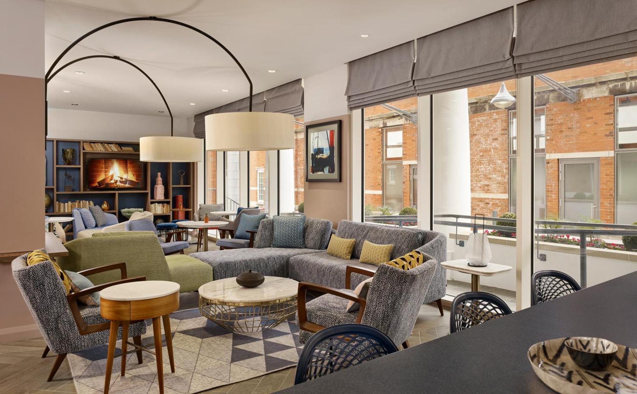 a living room with couches and chairs at Citadines Islington London in London