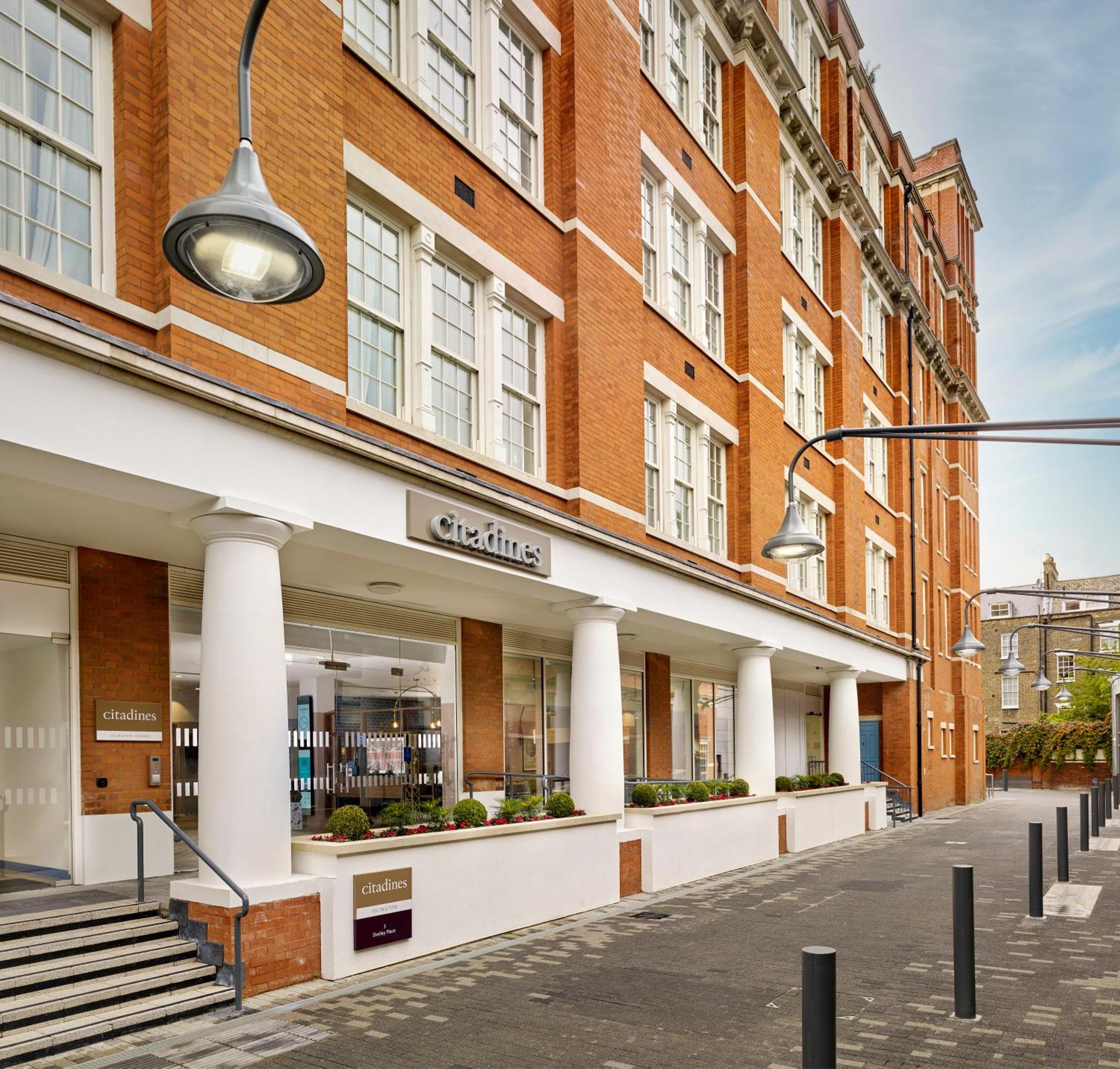 a store front of a brick building with white columns at Citadines Islington London in London