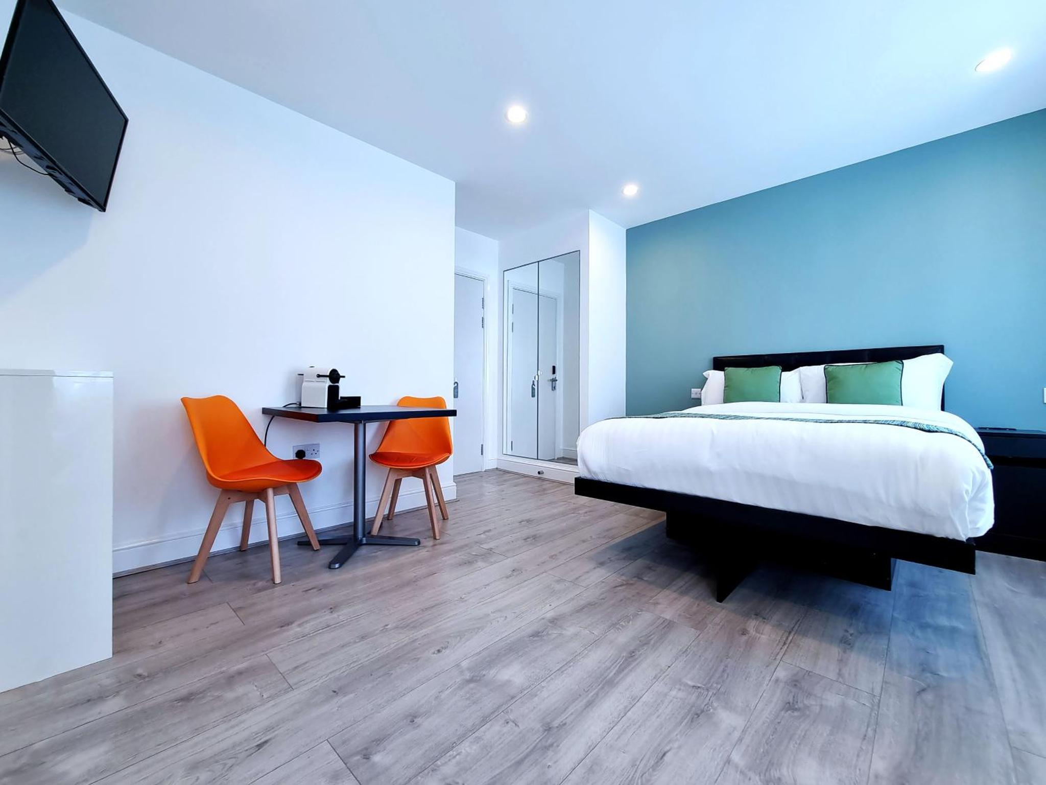 a bedroom with a bed and a table and chairs at 146 Studios in London