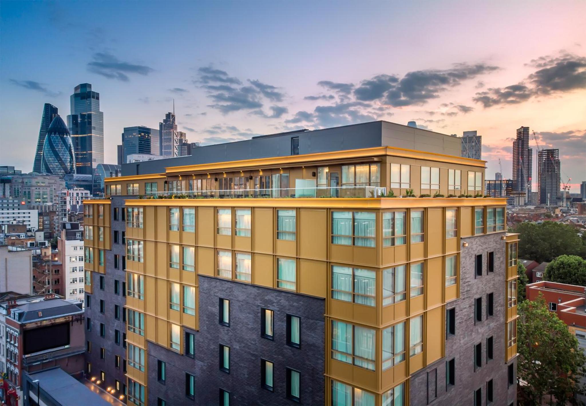 a building with a balcony on top of it at Hyatt Place London City East in London