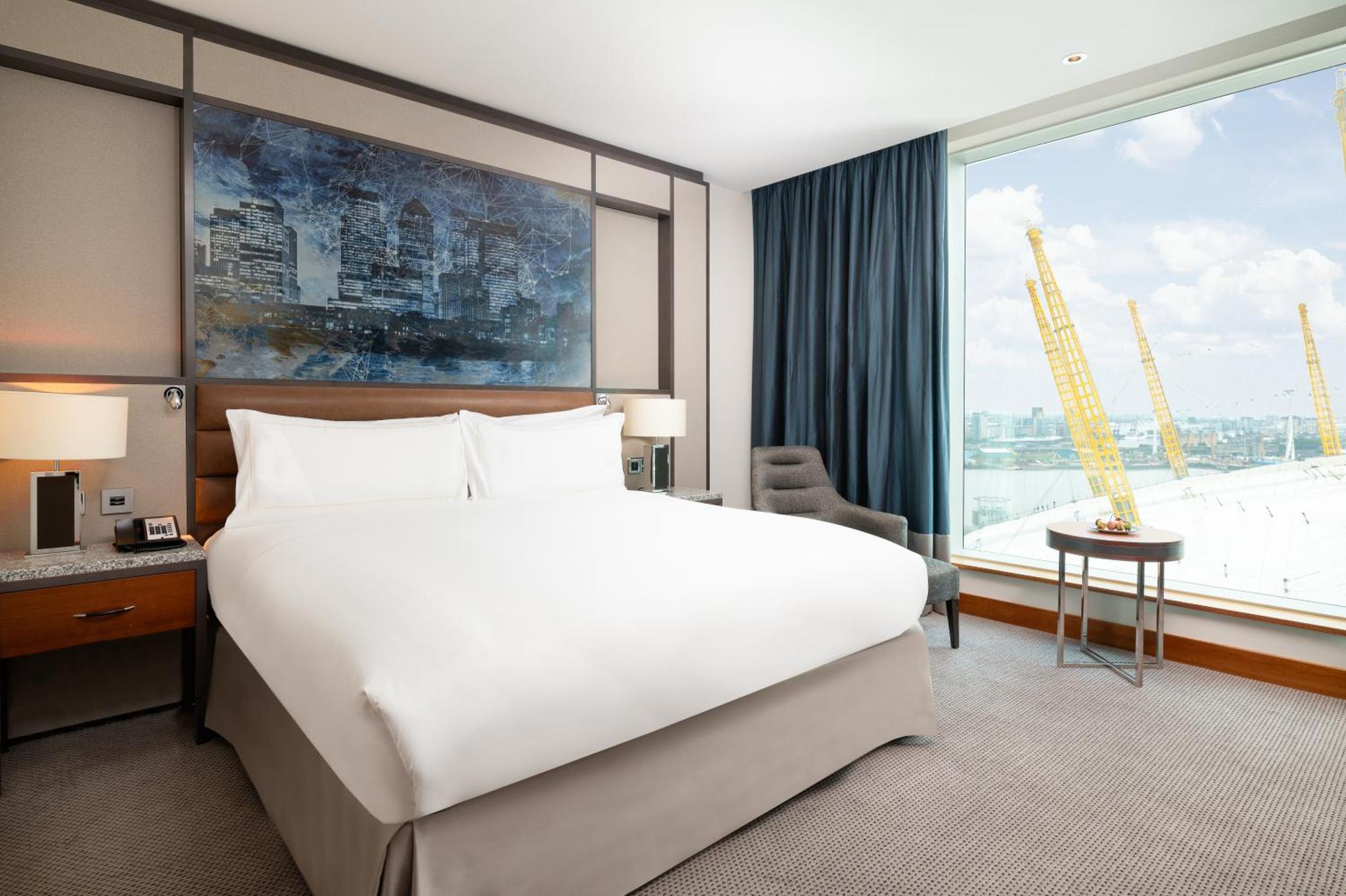 a bedroom with a large bed and a large window at InterContinental London - The O2 in London