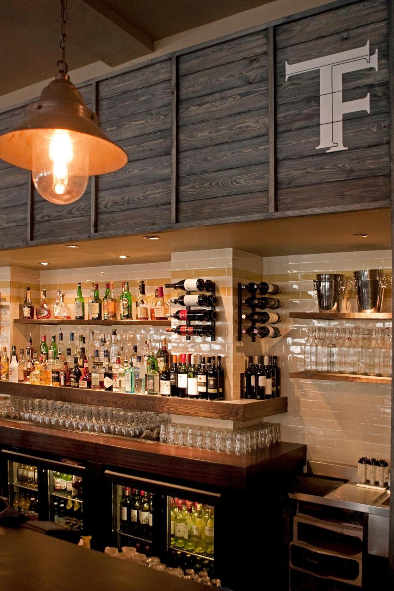 a bar with a lot of bottles of alcohol at The Tommyfield Hotel in London