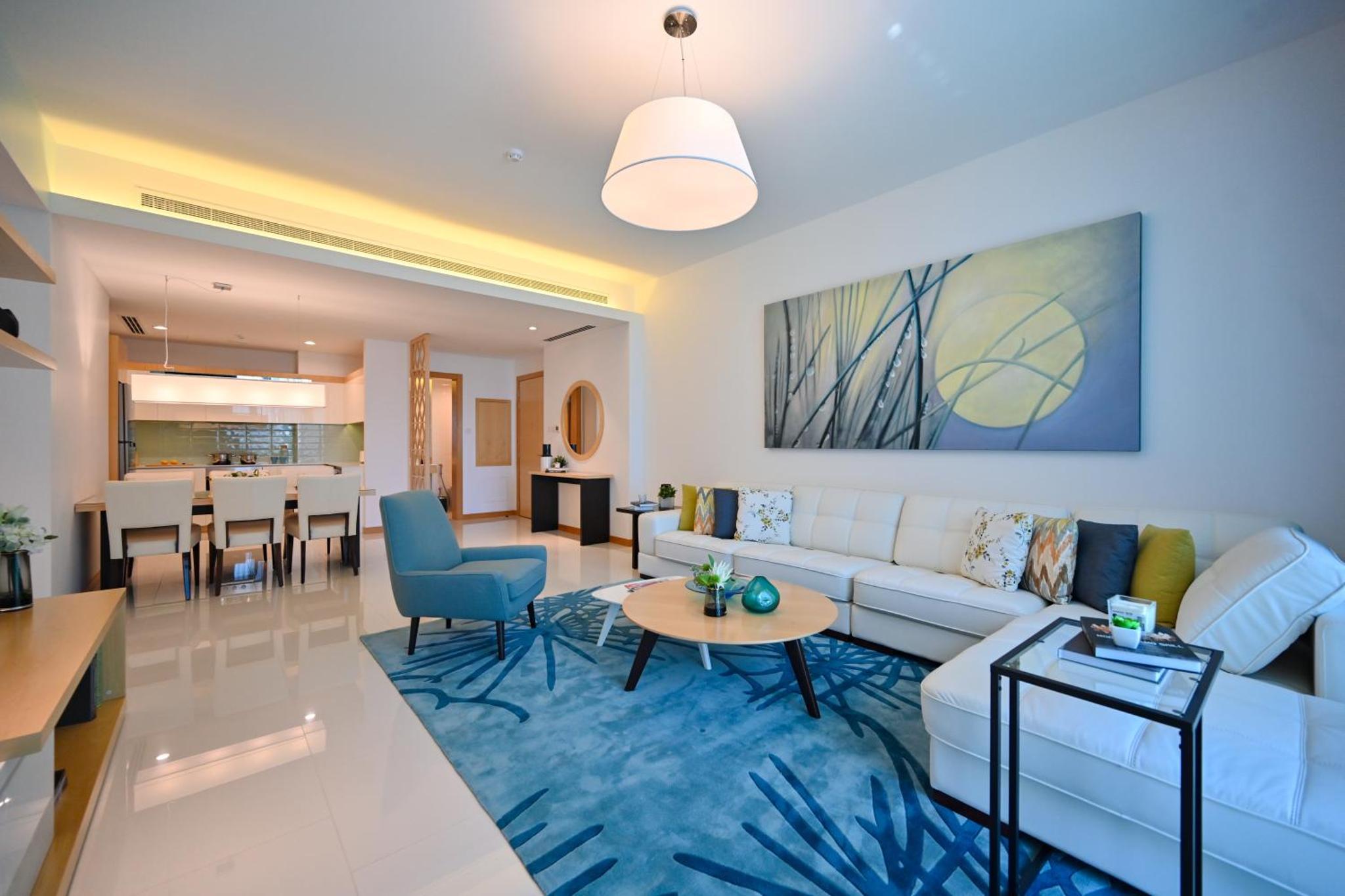 a living room with a couch and a table at Springfield Suites in Seef