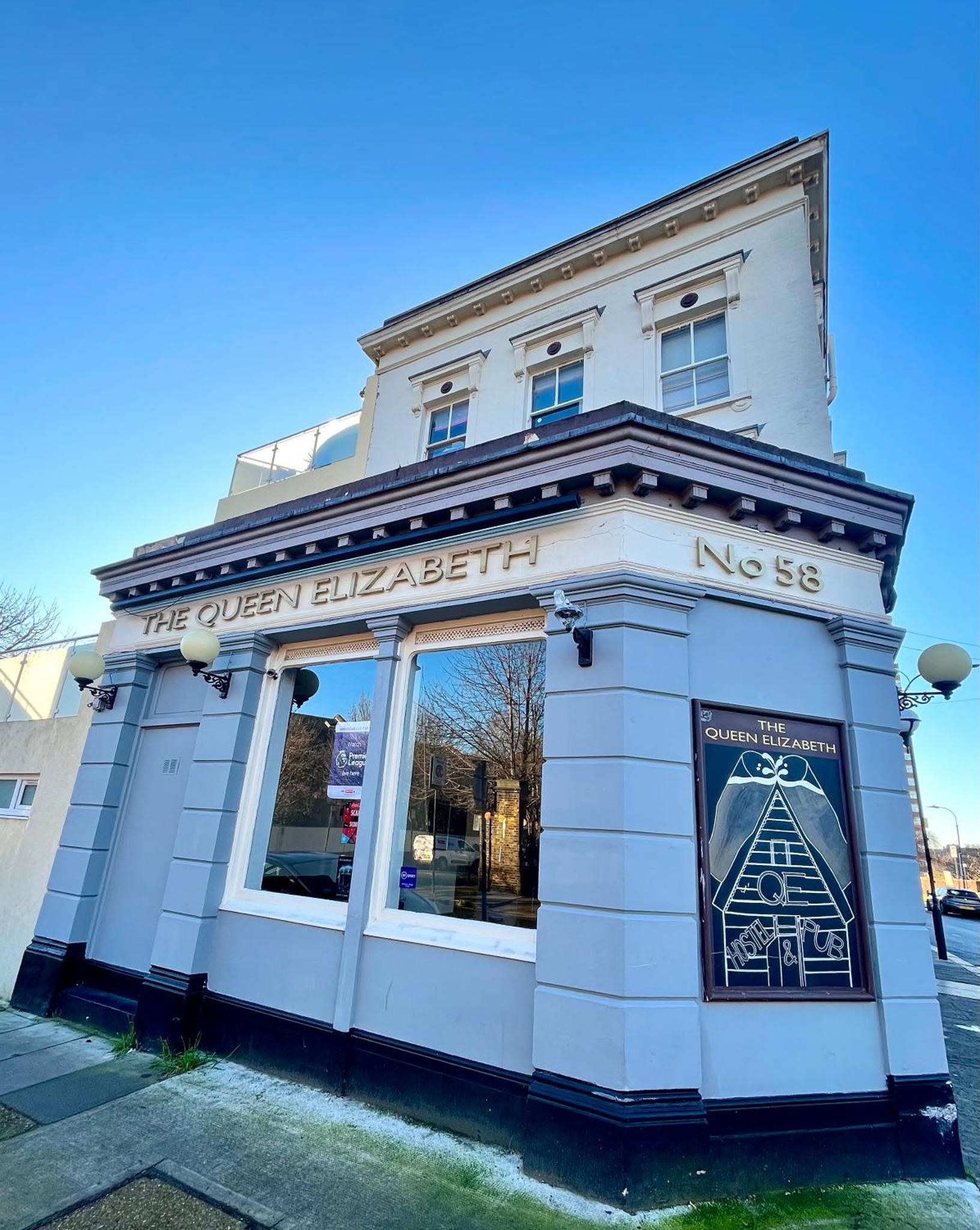 a white building with a sign in front of it at Queen Elizabeth Hostel in London