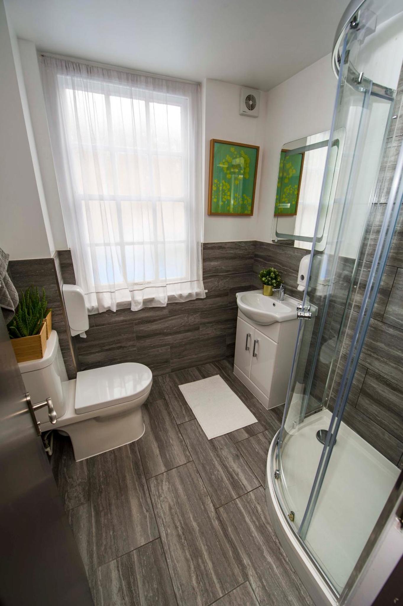 a bathroom with a toilet and a sink and a shower at Monopoly in London +51 photos