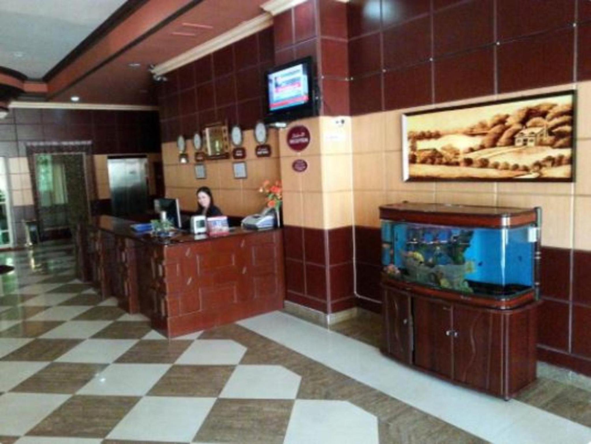 a lobby with a fish tank in a room at Oryx Tower in Manama +25 photos