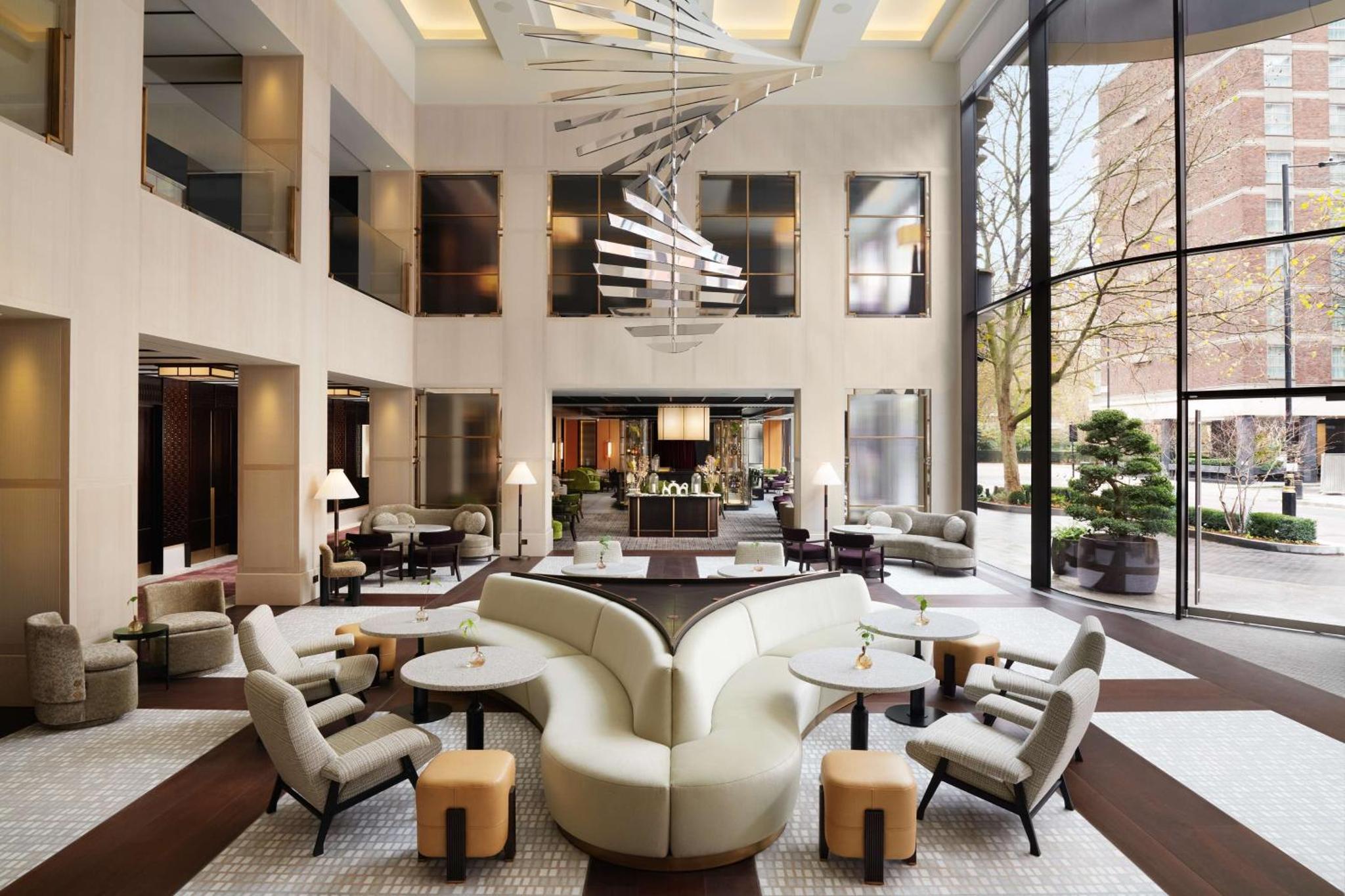 a lobby of a hotel with couches and tables at Nobu Hotel London Portman Square in London