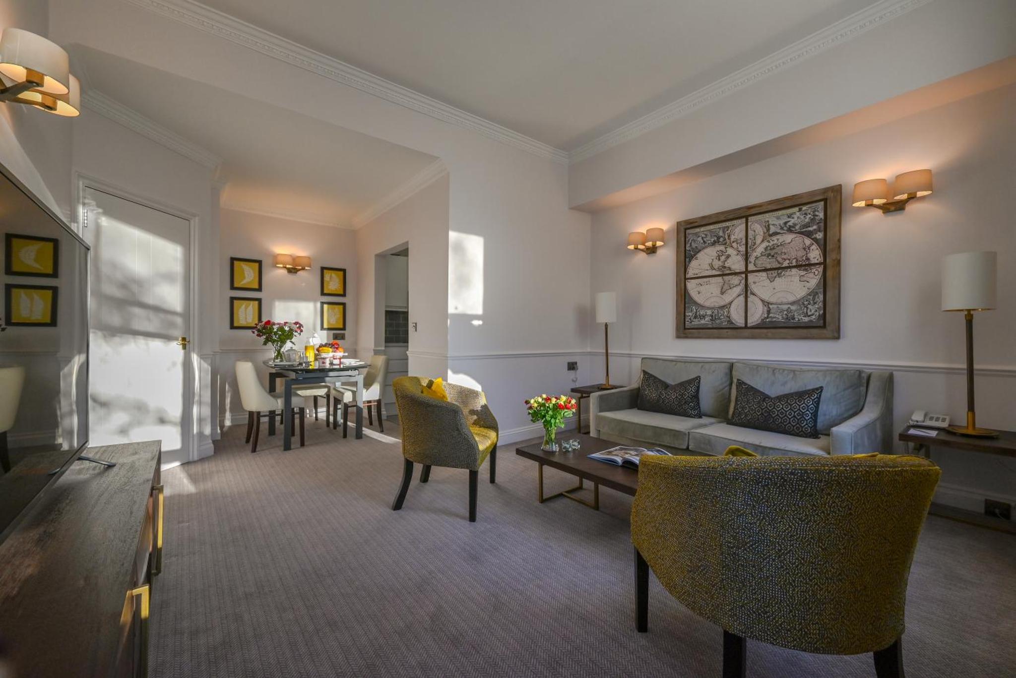 a living room with a couch and a table at Collingham Serviced Apartments in London