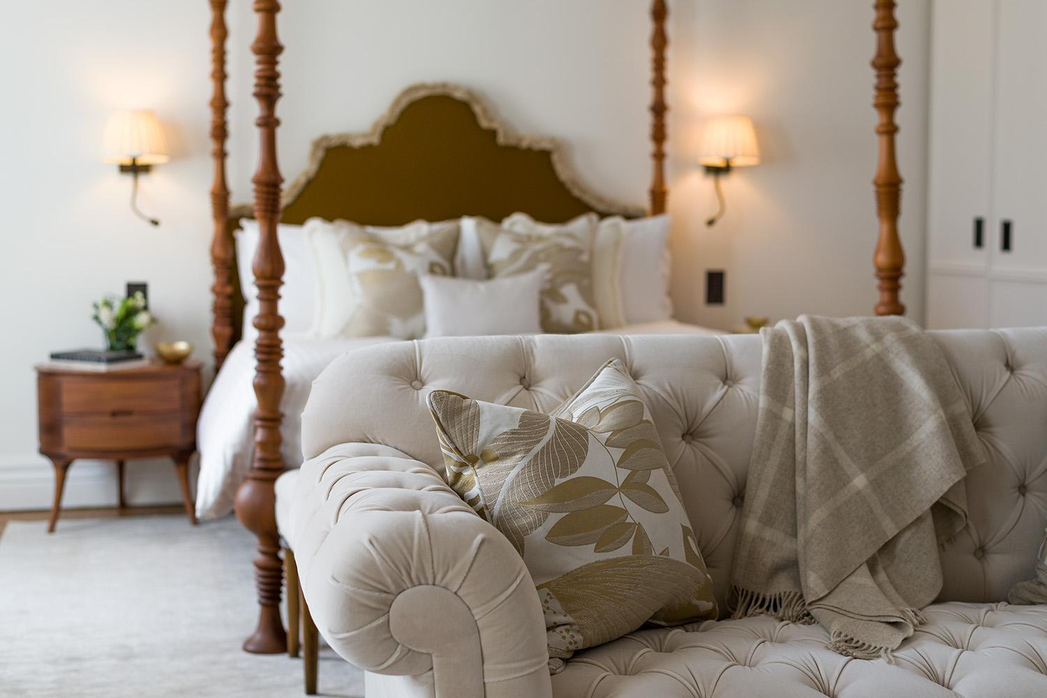 a bedroom with a bed and a couch with pillows at The Adria in London