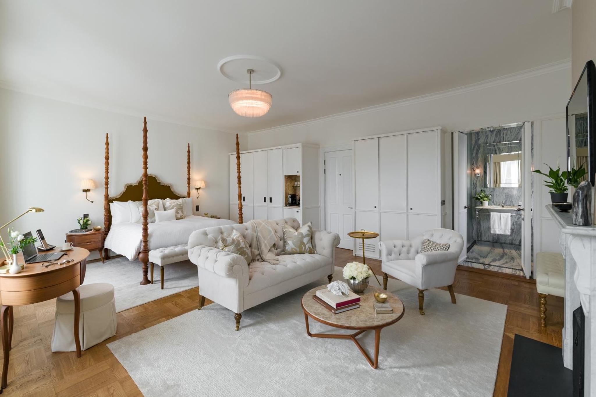 a living room with two white couches and a table at The Adria in London +104 photos