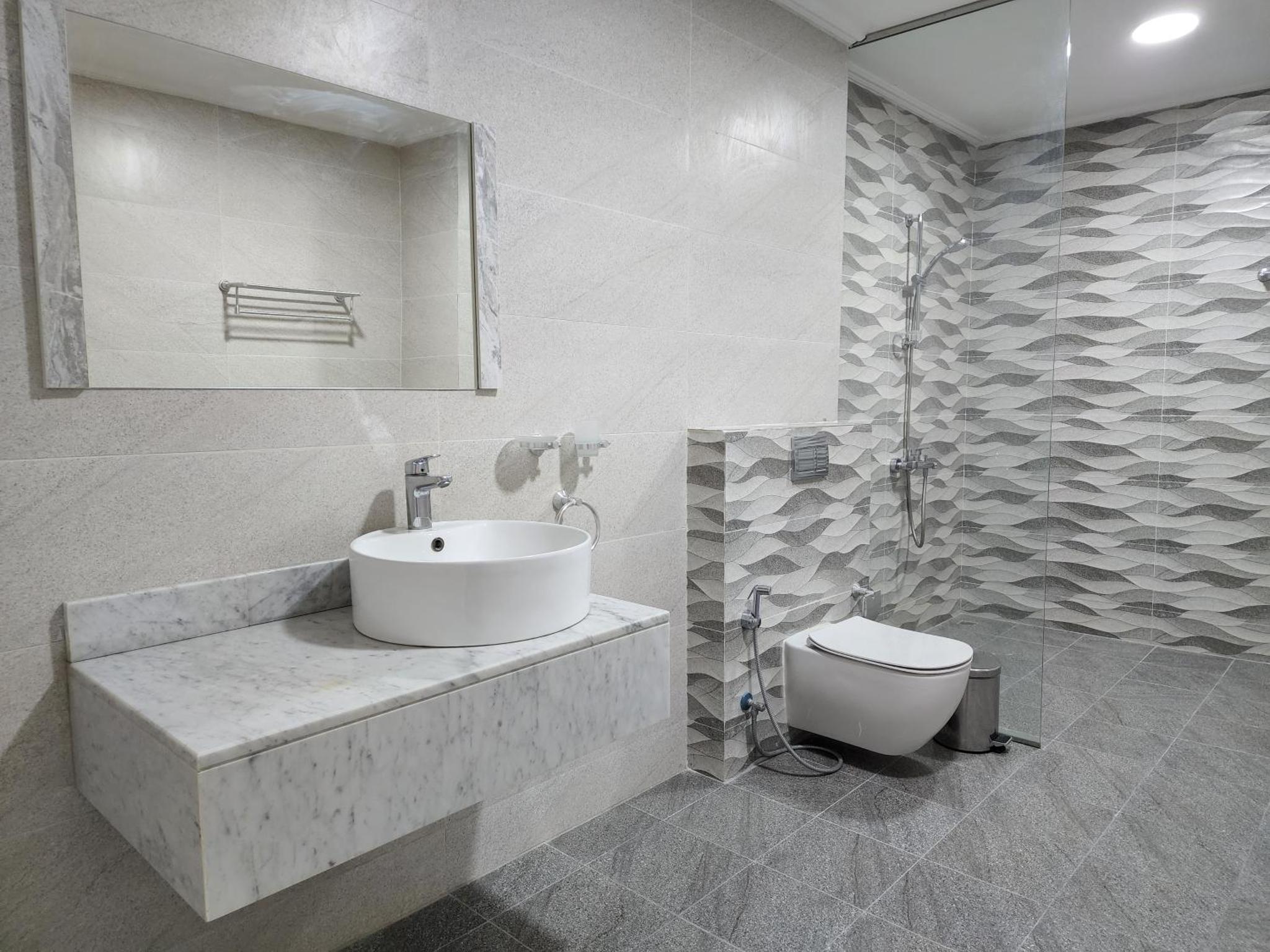 a white bathroom with a sink and a toilet at Imperial Suites Hotel in Manama +43 photos