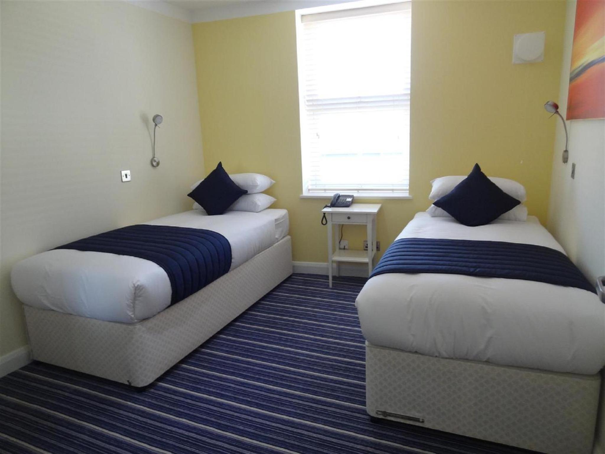 a hotel room with two beds and a couch at Hotel Unique in London +11 photos