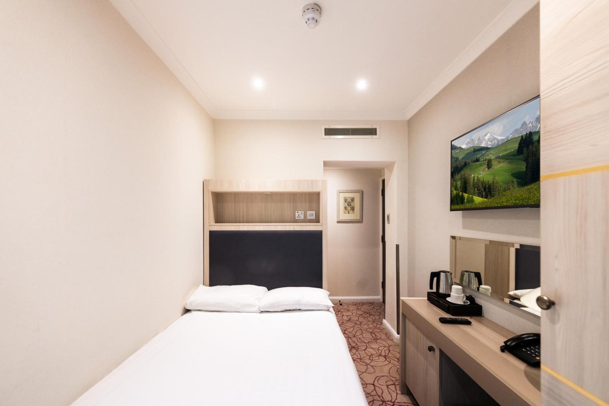 a hotel room with a bed and a sink at Blandford Hotel in London