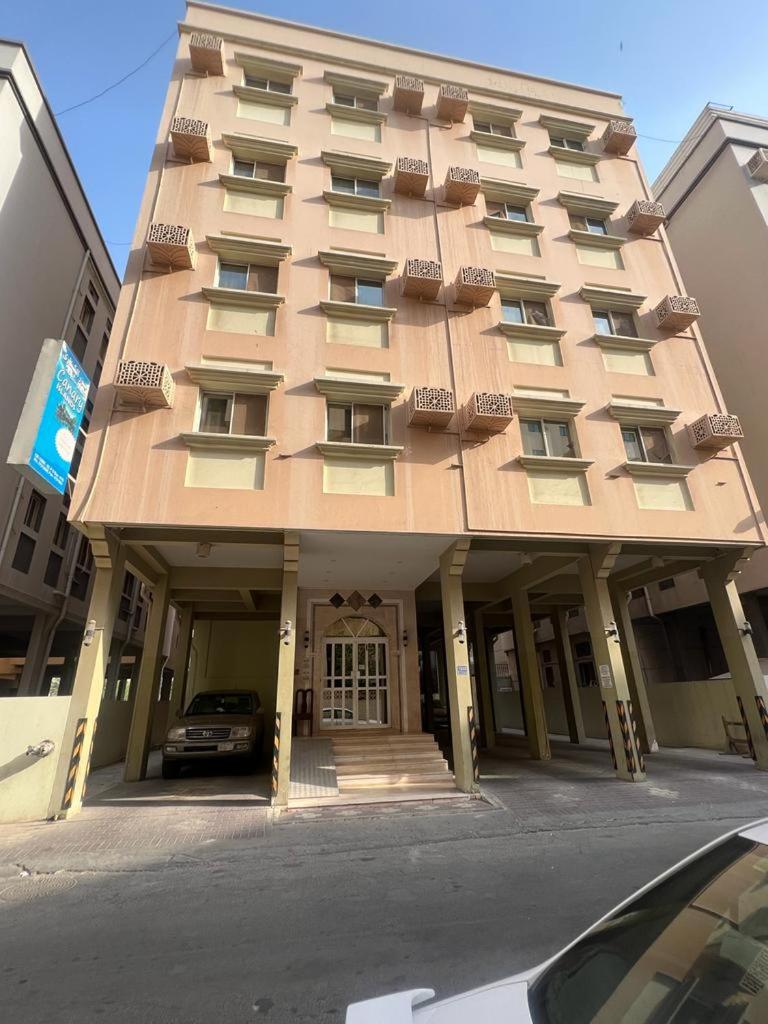 a large apartment building with a front door at Canary Islands in Manama