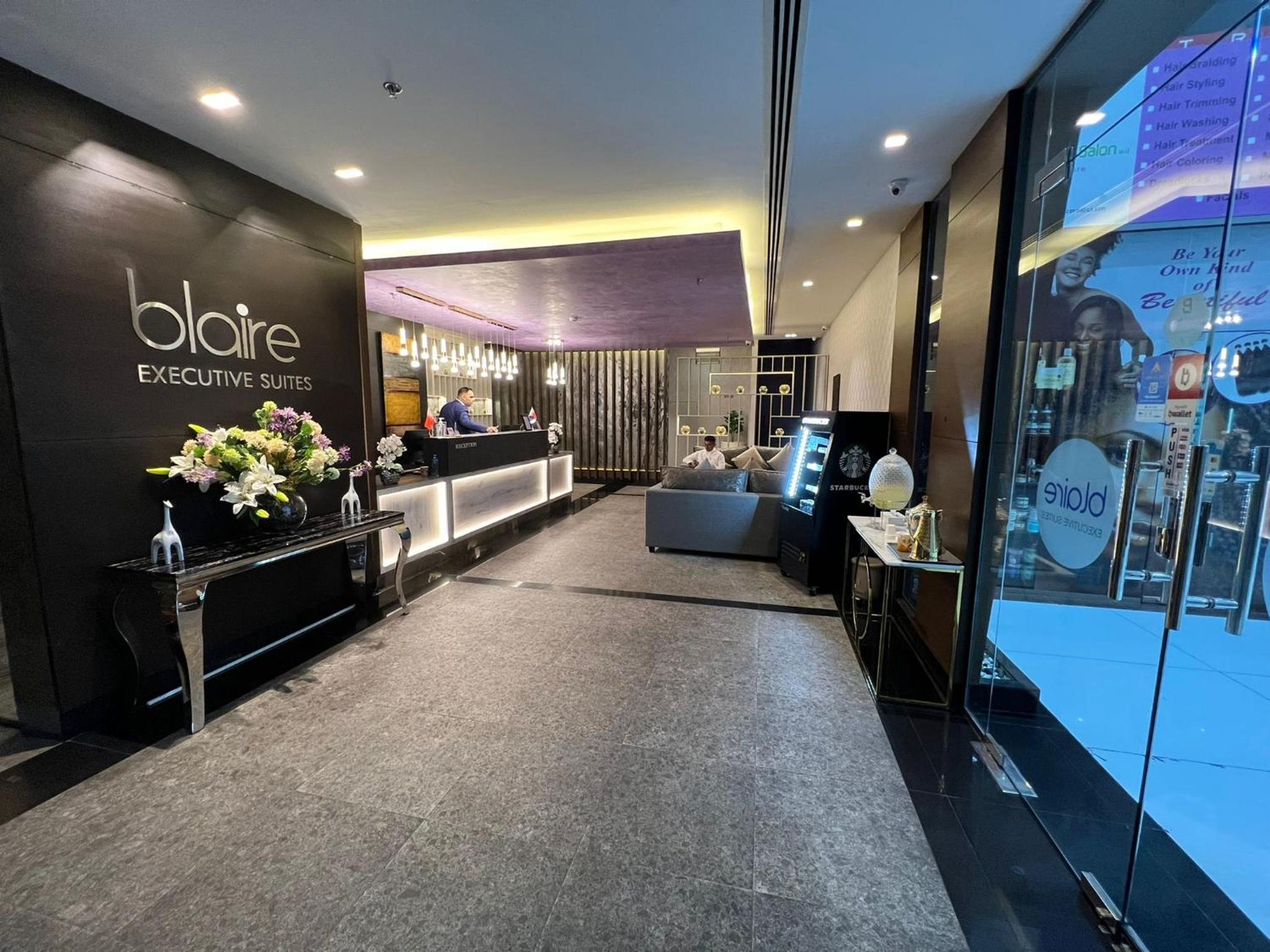 a view of a store lobby with people in the salon at Blaire Executive Suites in Manama +84 photos