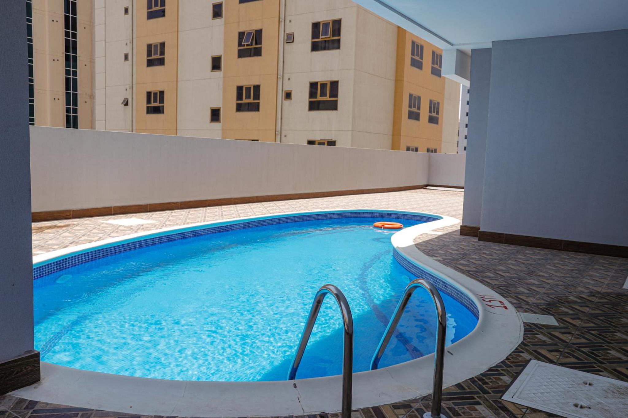 a large swimming pool in the middle of a building at SIRIUS TOWER in Juffair