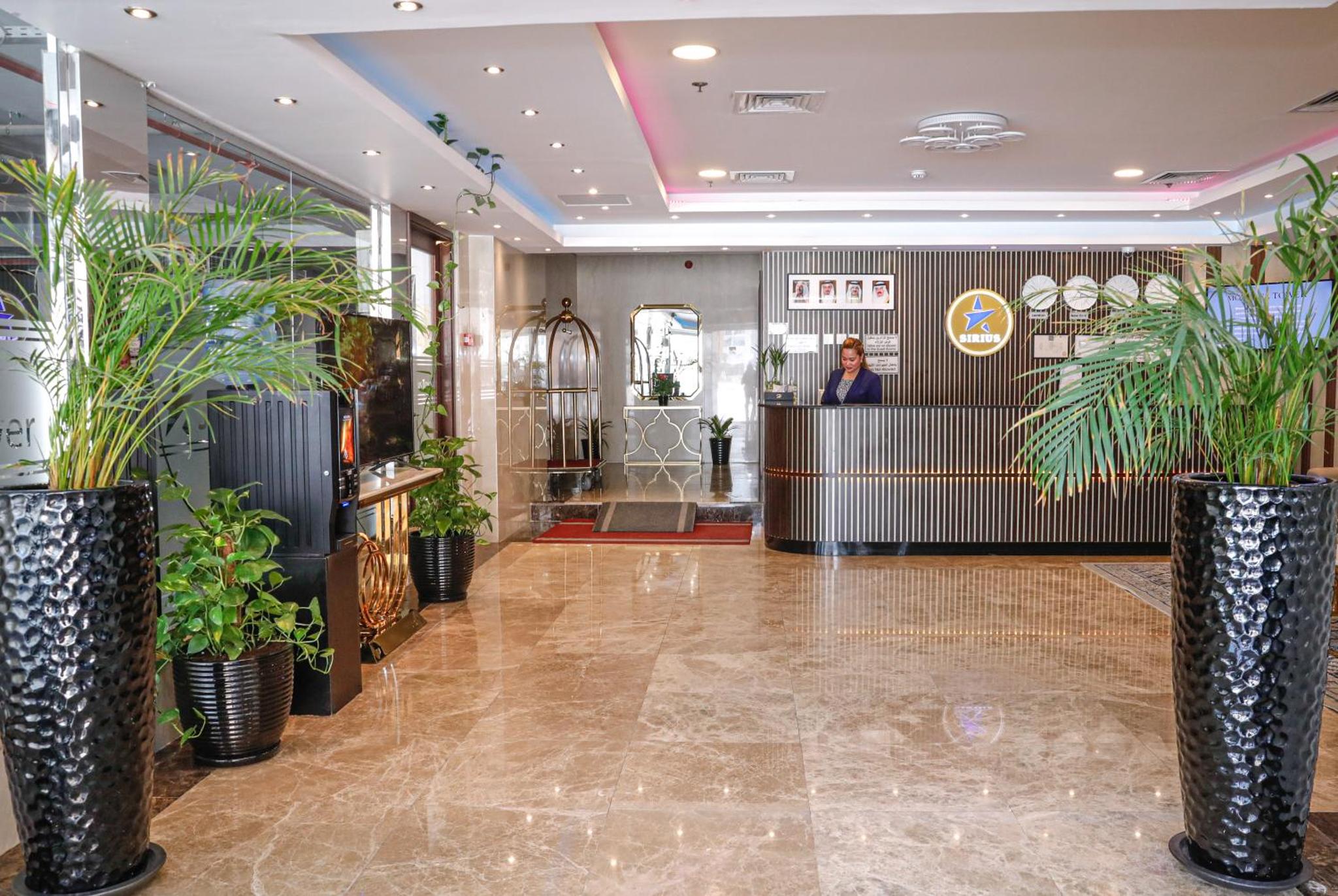 a man standing in a lobby with plants at SIRIUS TOWER in Juffair +62 photos