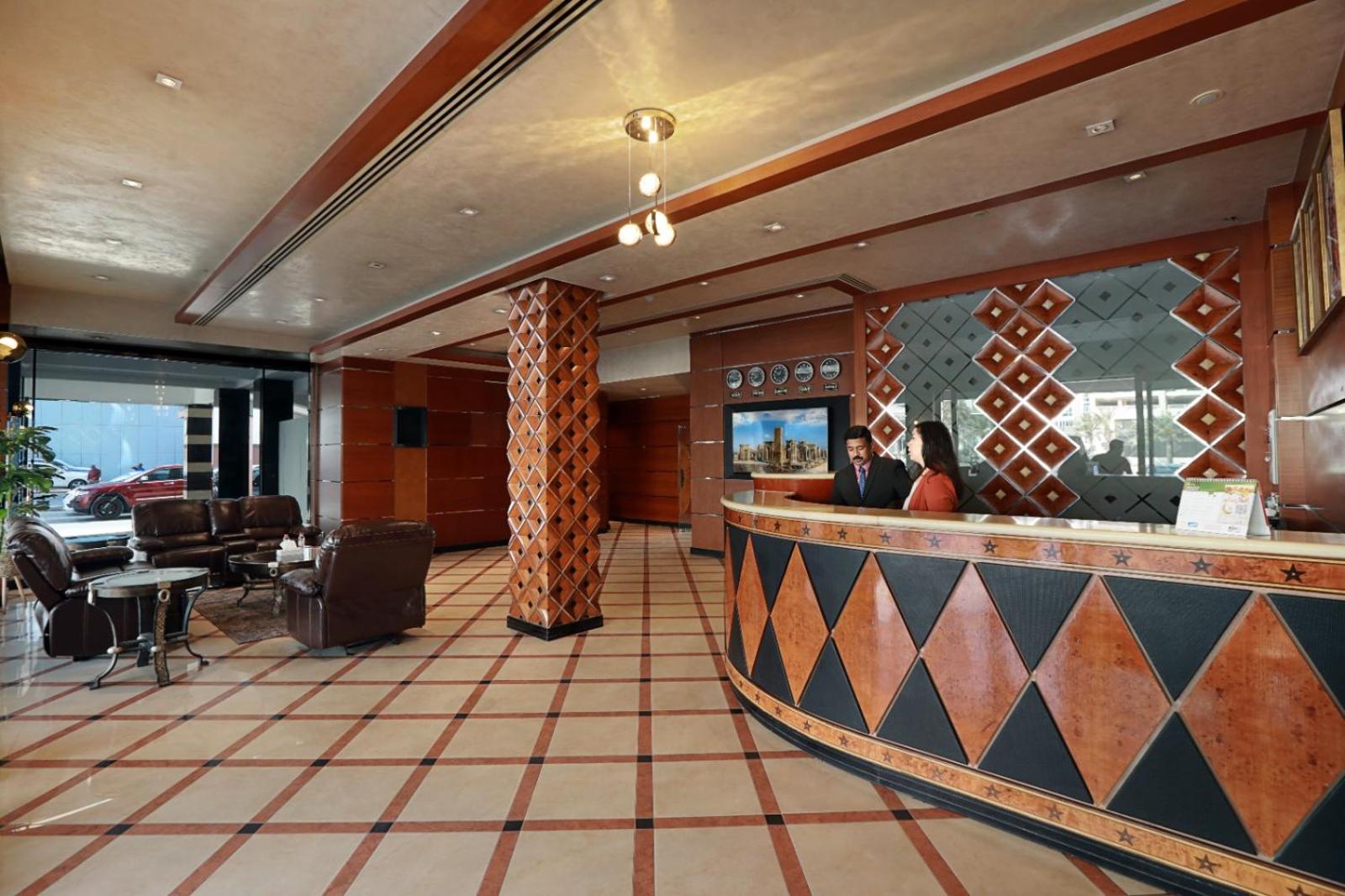 a restaurant with a bar with people sitting at a counter at Elite Tower in Seef