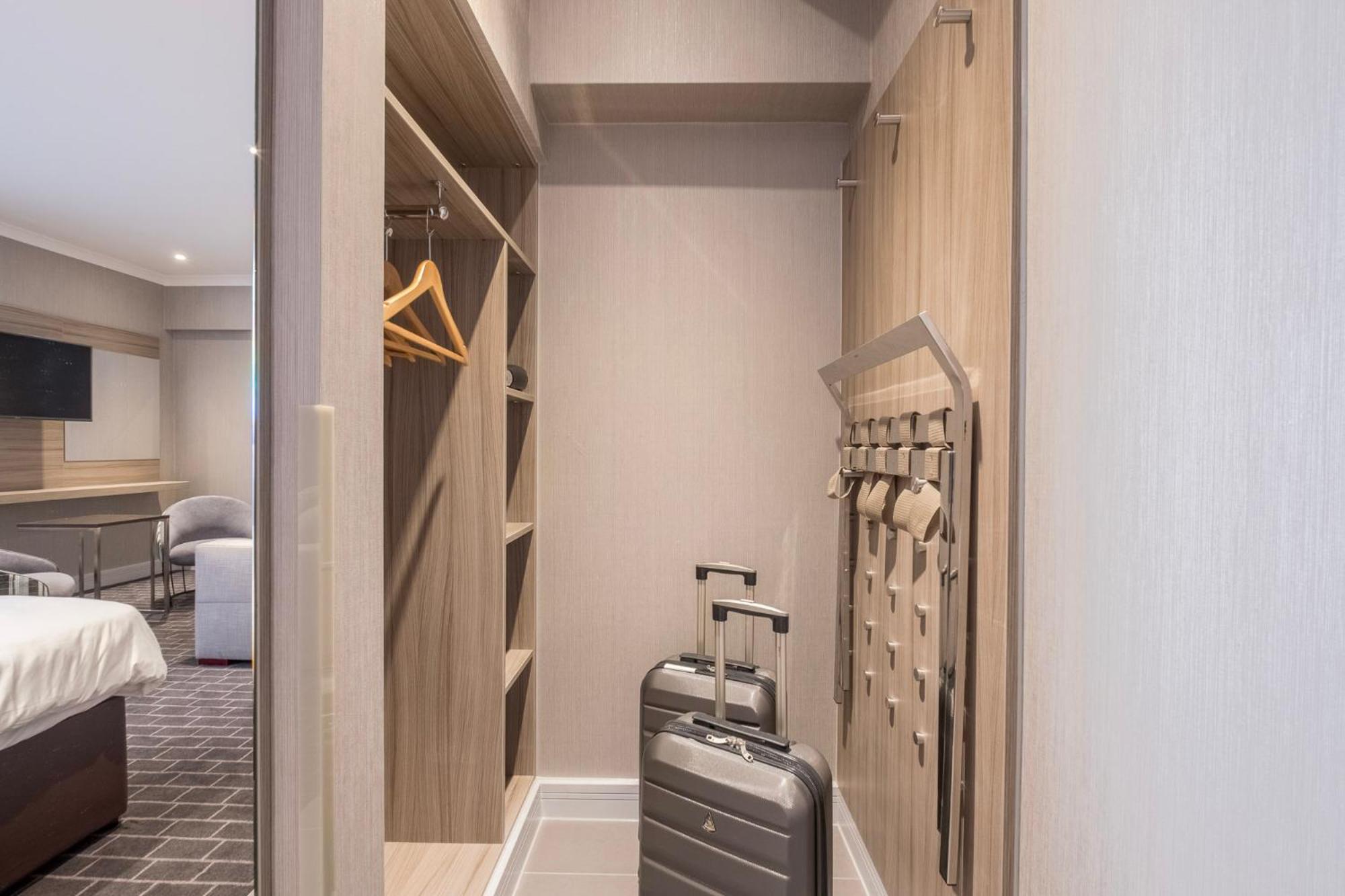 a walk in closet with a suitcase in a room at City Sleeper at Royal National Hotel in London