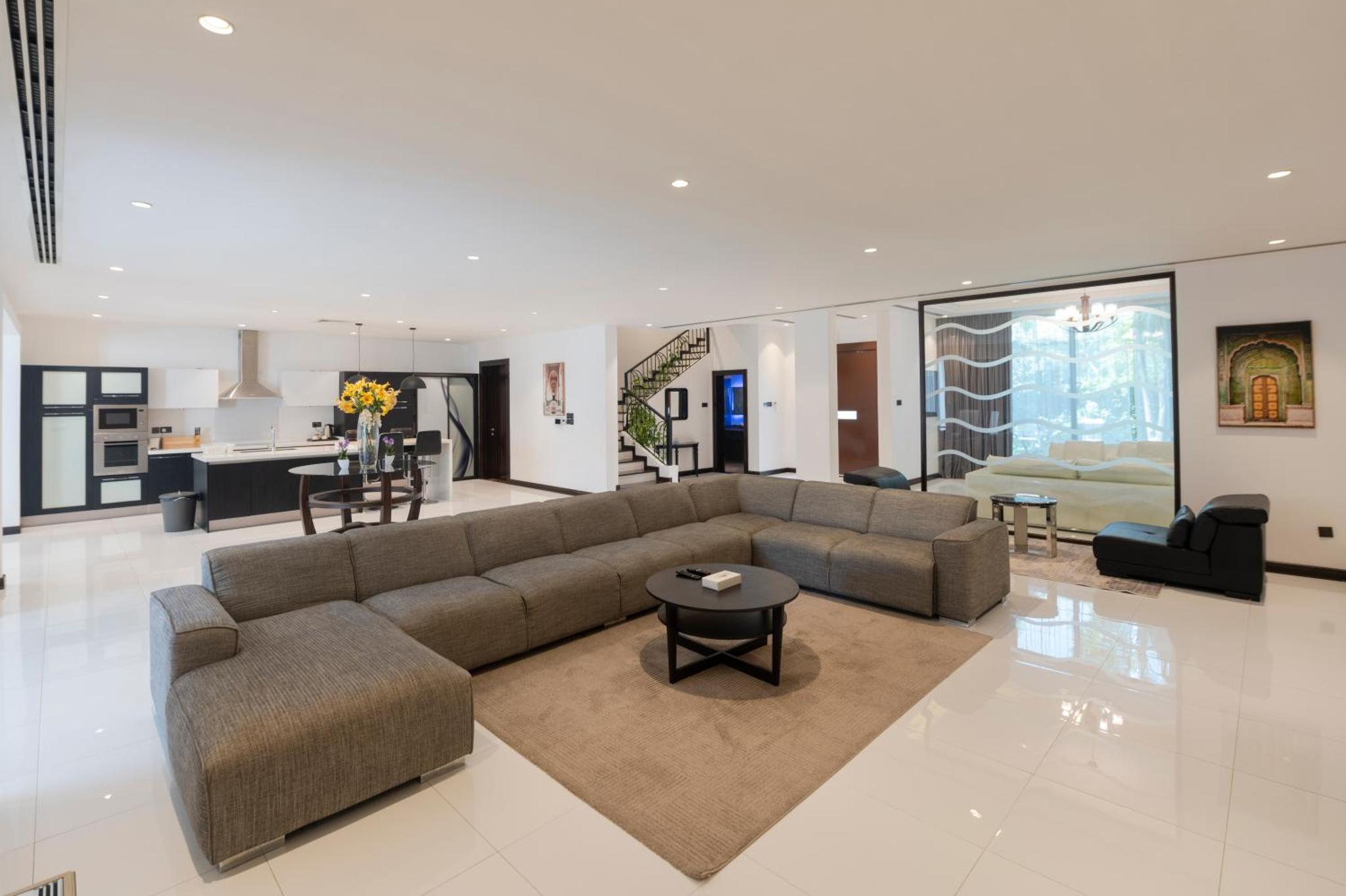 a living room with a couch and a table at Nordic Resort in Manama