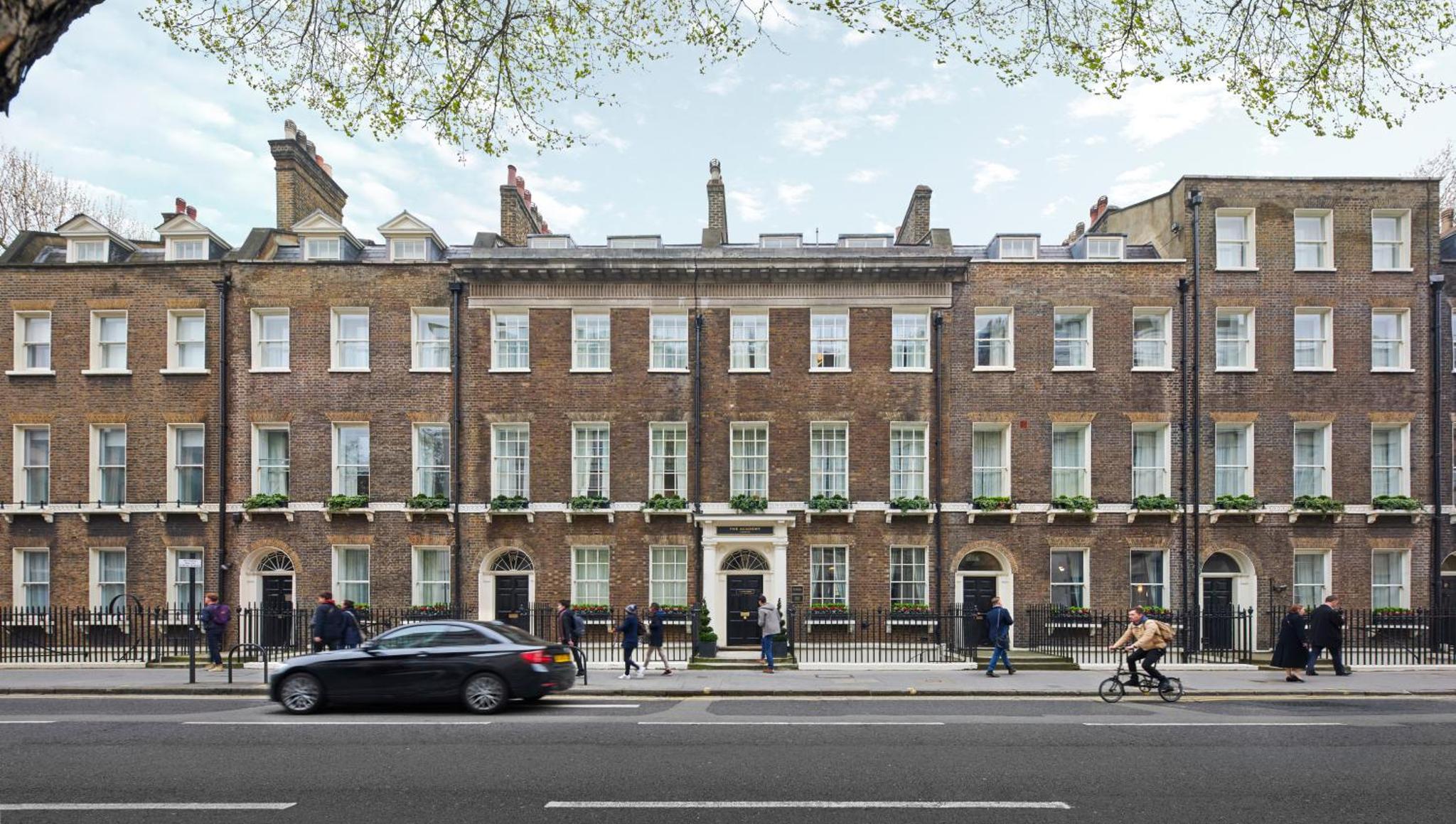 a car parked in front of a large brick building at The Academy - Small Luxury Hotels of the World in London