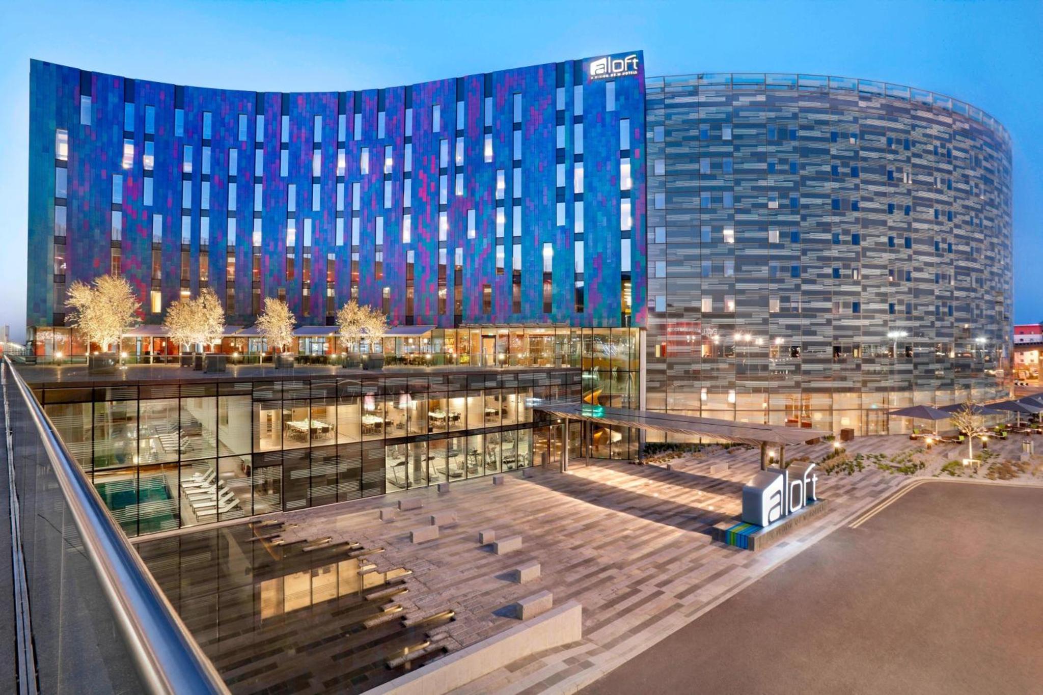 a view of a large building at night at Aloft London Excel in London