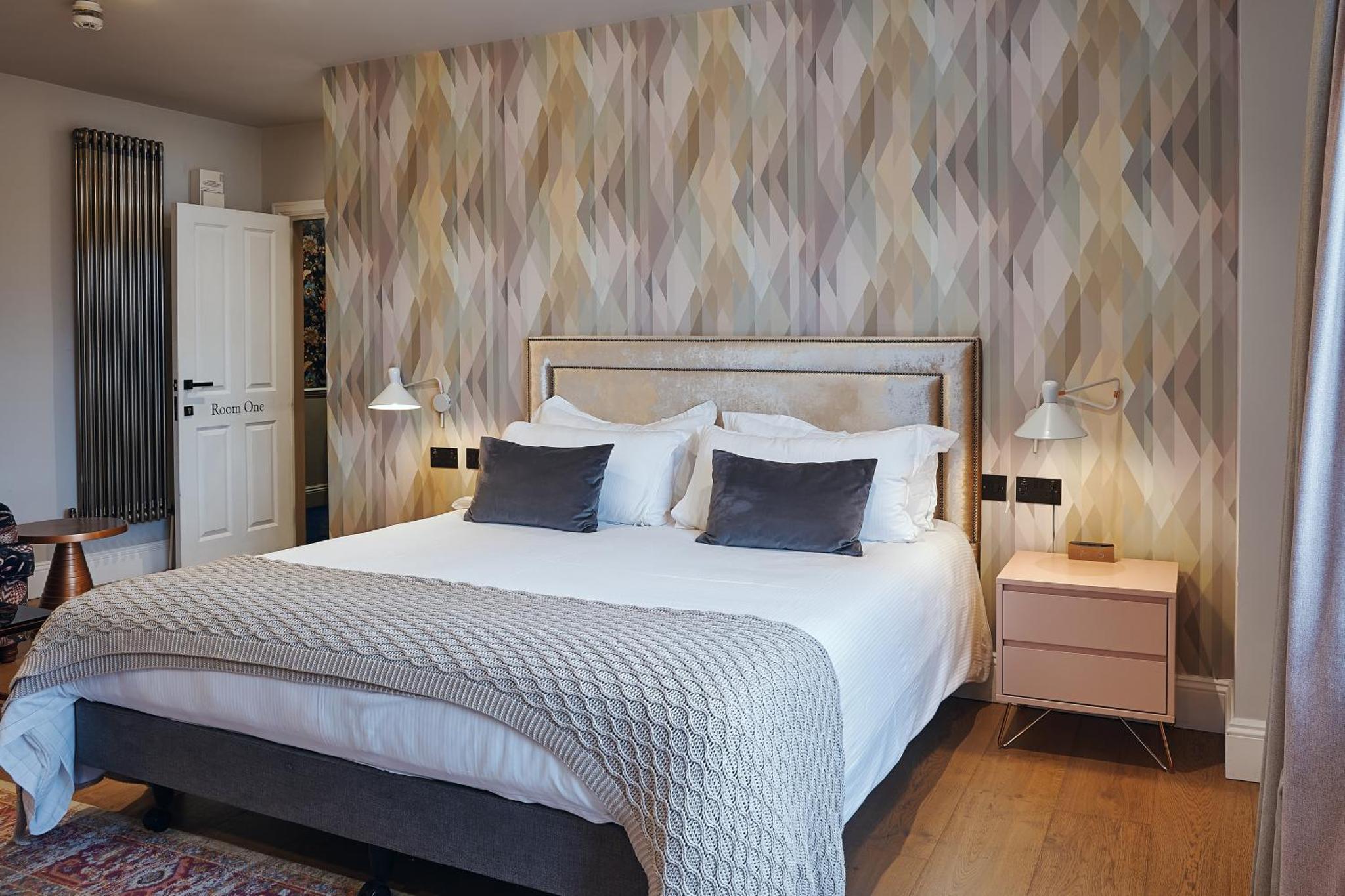 a bedroom with a large bed with two pillows at The Brownswood in London +55 photos