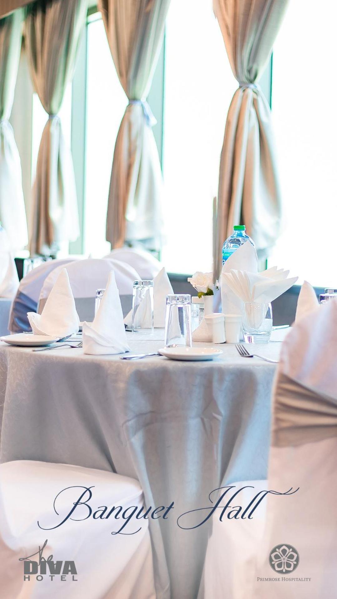 a table with a white table cloth on it at Diva Hotel in Manama +33 photos