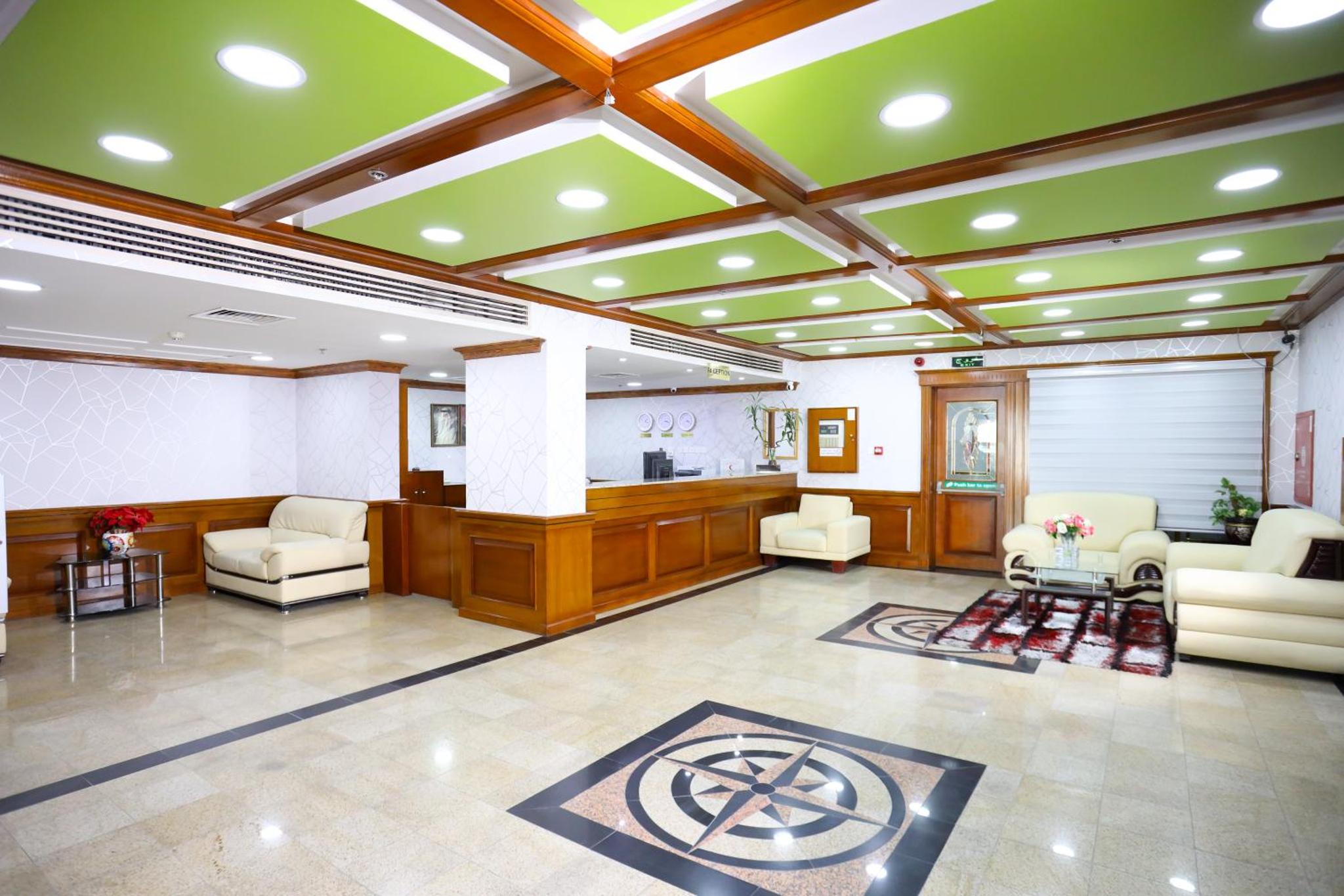 a lobby with a waiting area with chairs and tables at Pearl Bahrain Suites in Manama +124 photos