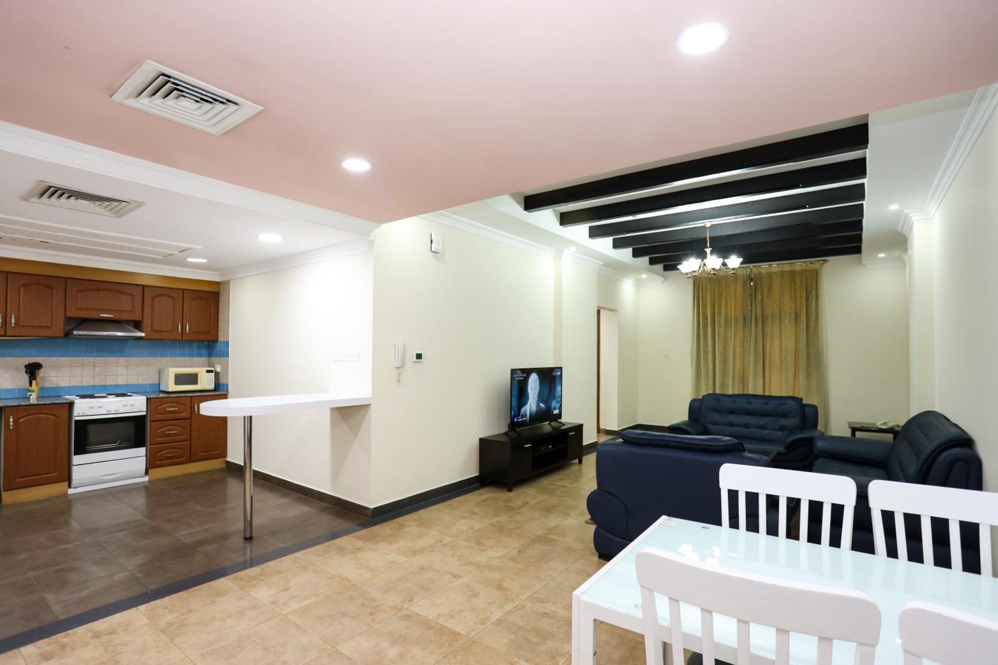 a living room with a couch and a table at Pearl Bahrain Suites in Manama