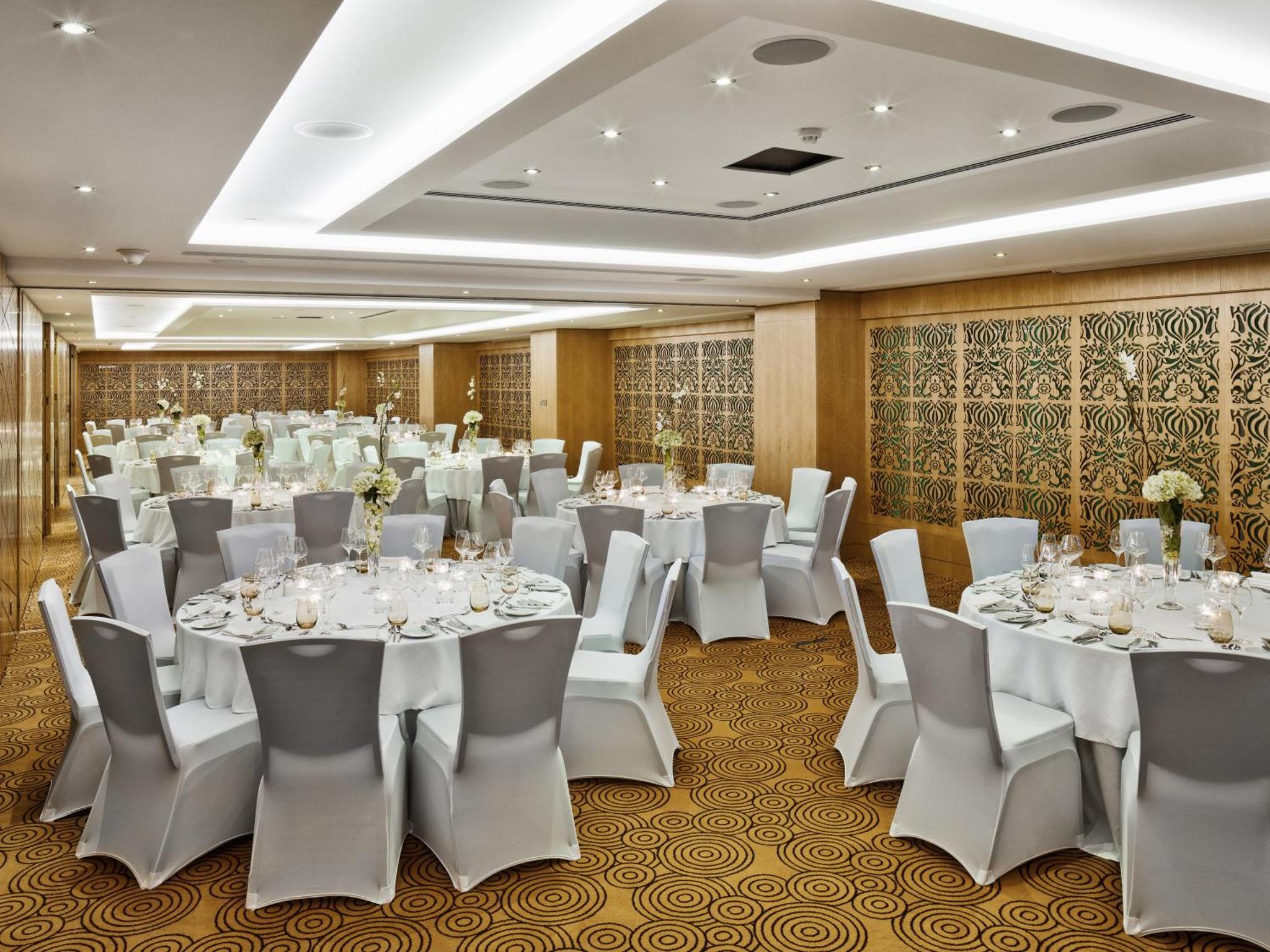 a banquet hall with white tables and white chairs at The Domain Bahrain Hotel and Spa - Adults Friendly 16 Years Plus in Manama +68 photos