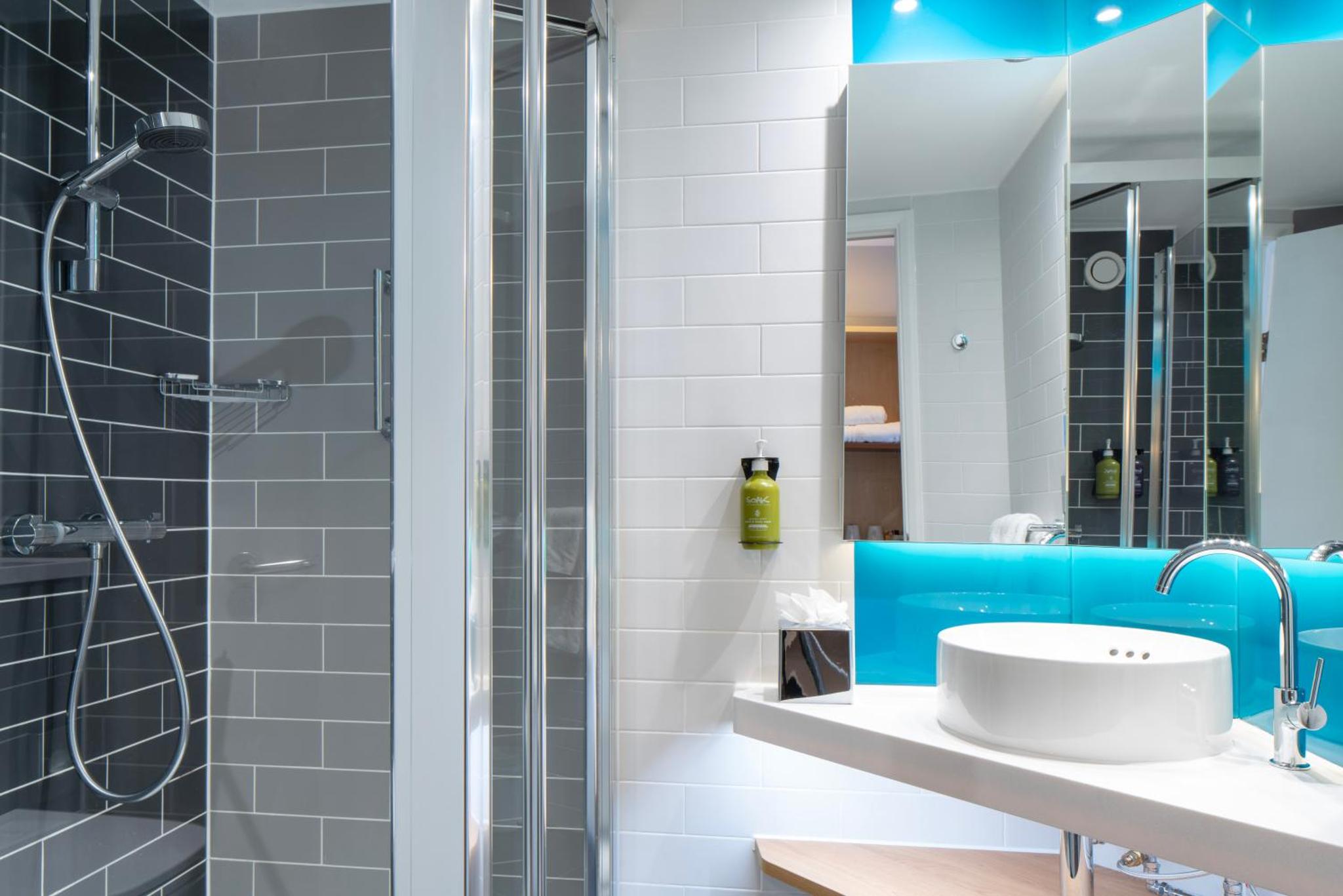 a bathroom with a sink and a shower at Holiday Inn Express Southwark by IHG in London +34 photos
