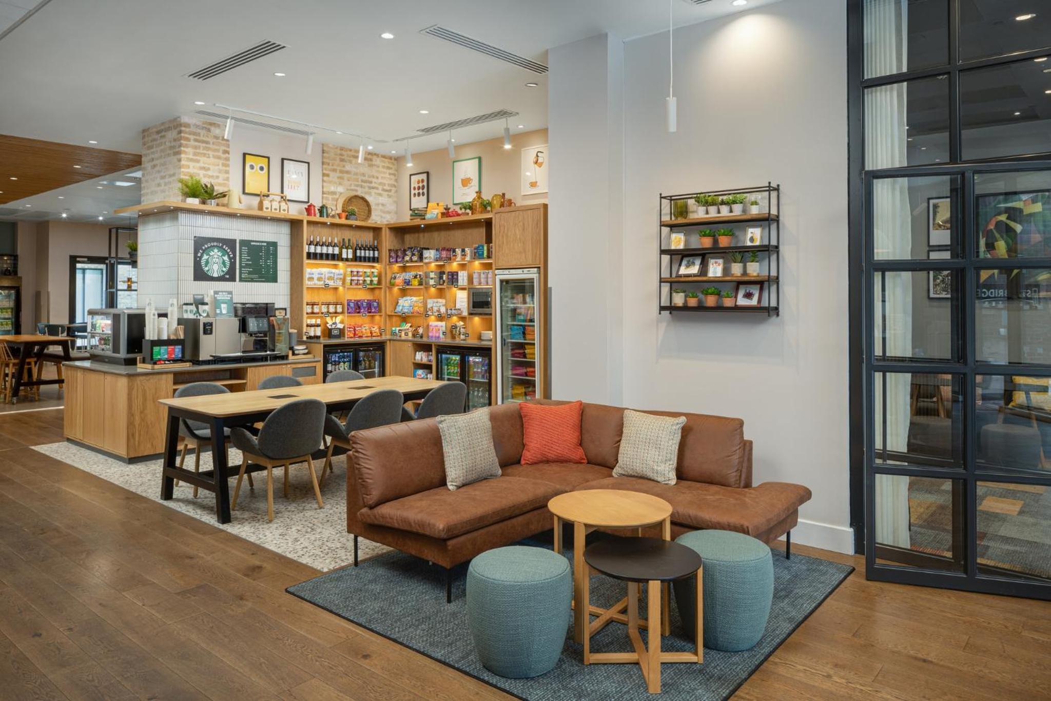 a living room with a couch and a table and chairs at Staybridge Suites London-Vauxhall by IHG in London