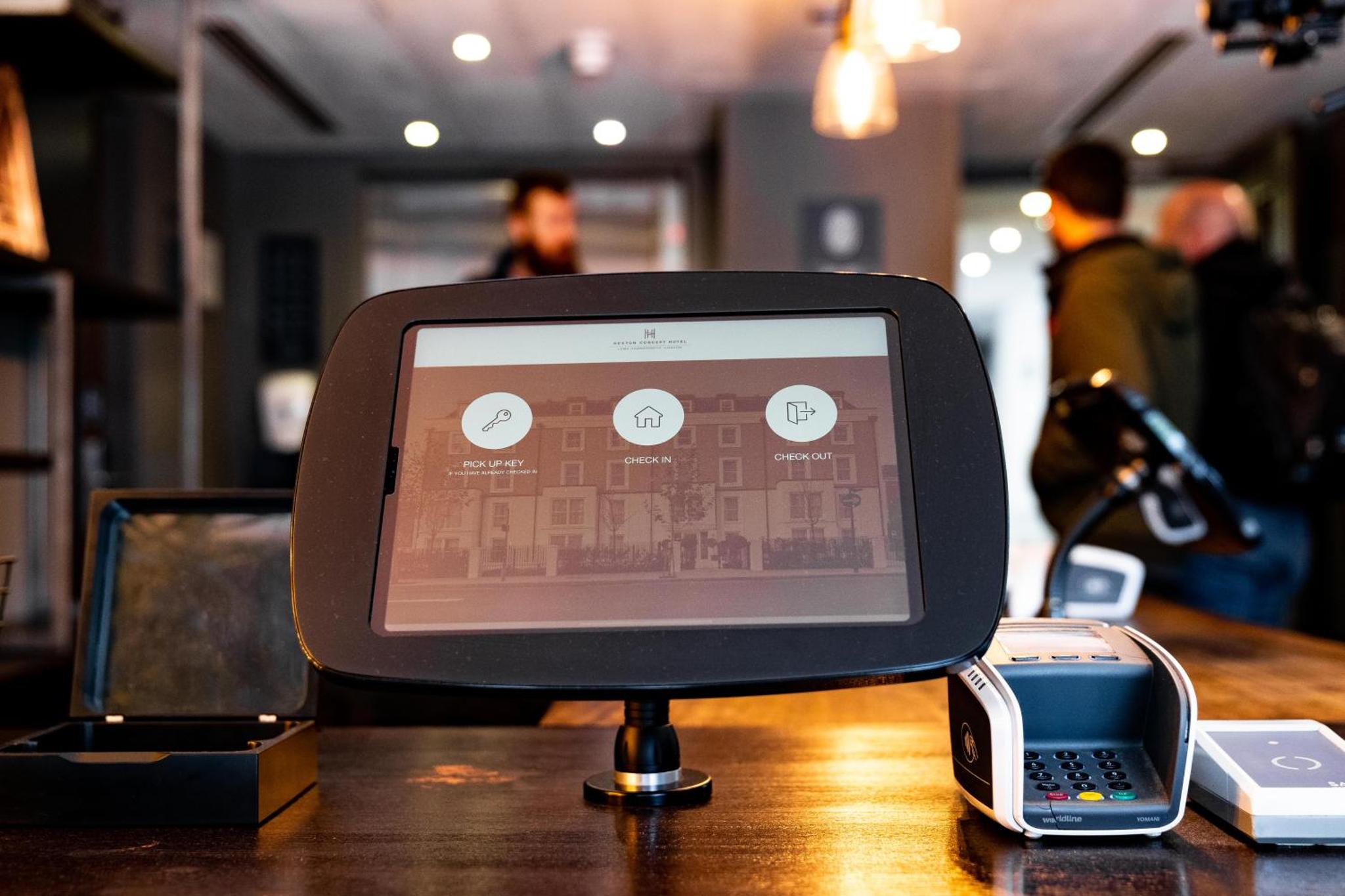 a tablet computer sitting on a table with a cell phone at Heeton Concept Hotel – Luma Hammersmith in London