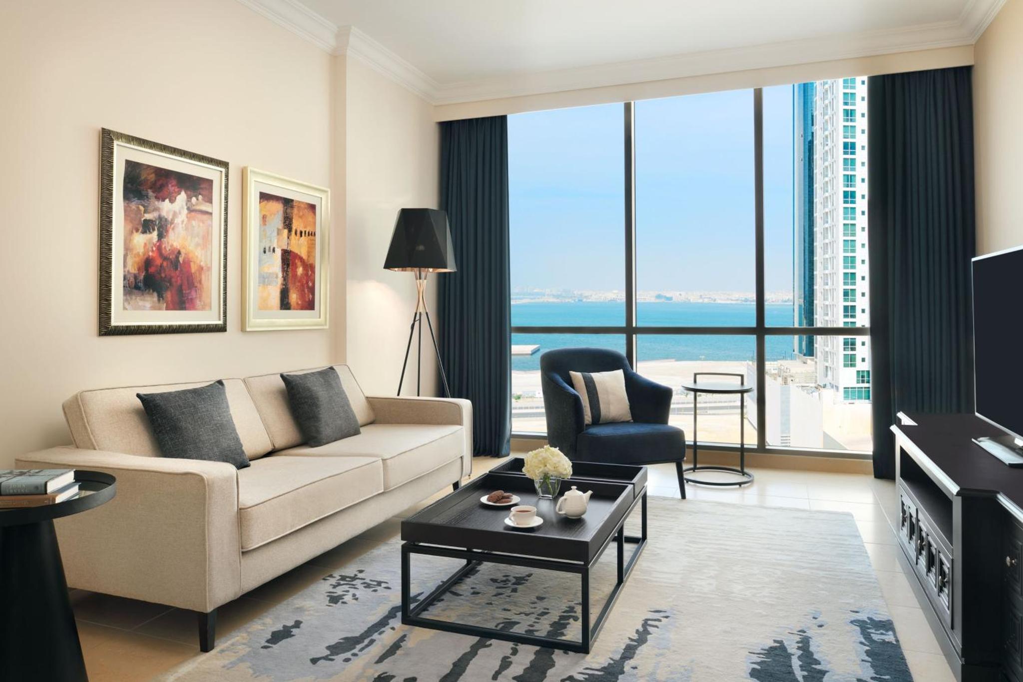 a living room with a couch and a table at Marriott Executive Apartments Manama, Bahrain in Manama