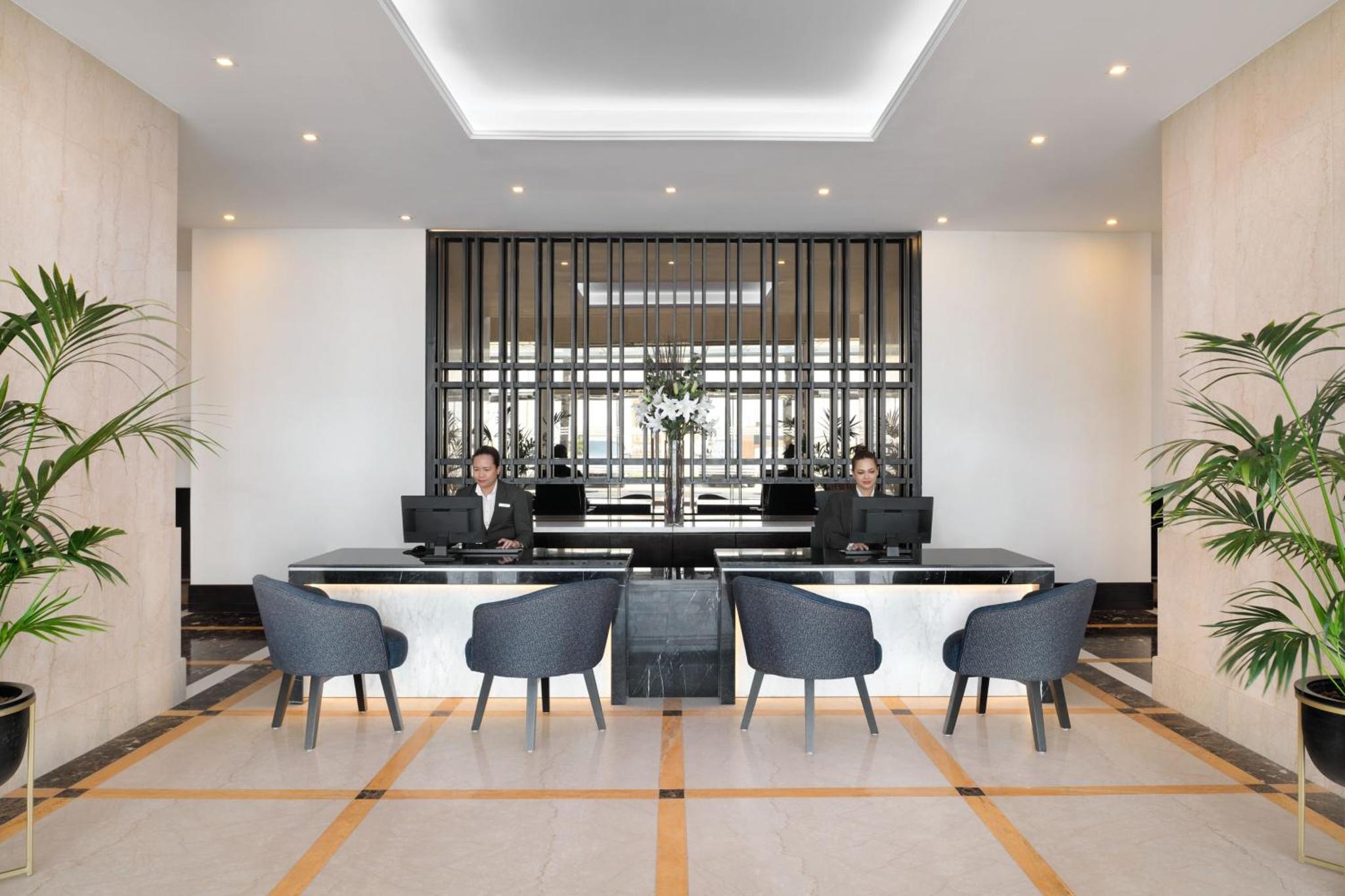 two people sitting at a table with their laptops at Marriott Executive Apartments Manama, Bahrain in Manama +30 photos