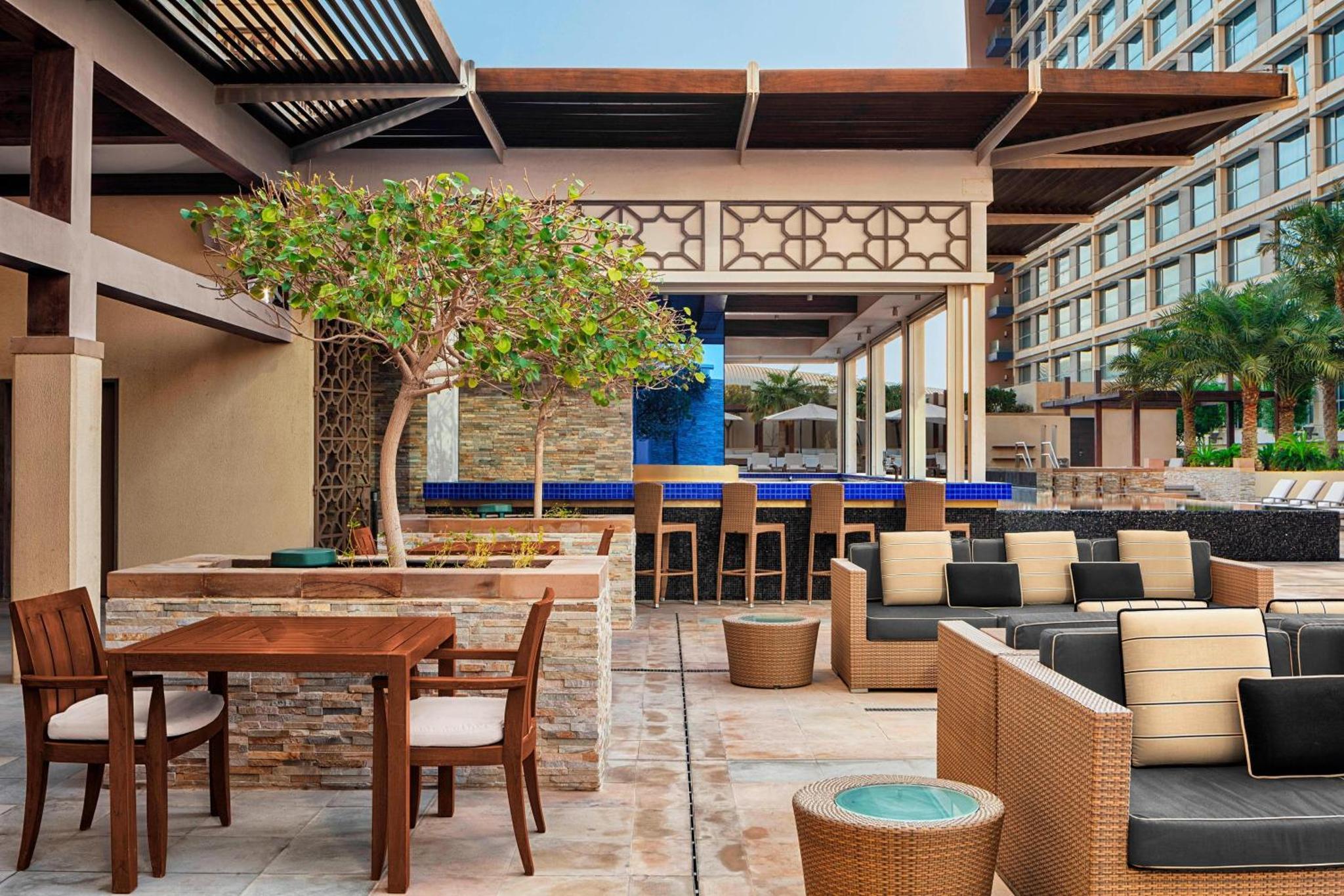a patio with a table and chairs and a building at The Westin City Centre Bahrain in Manama