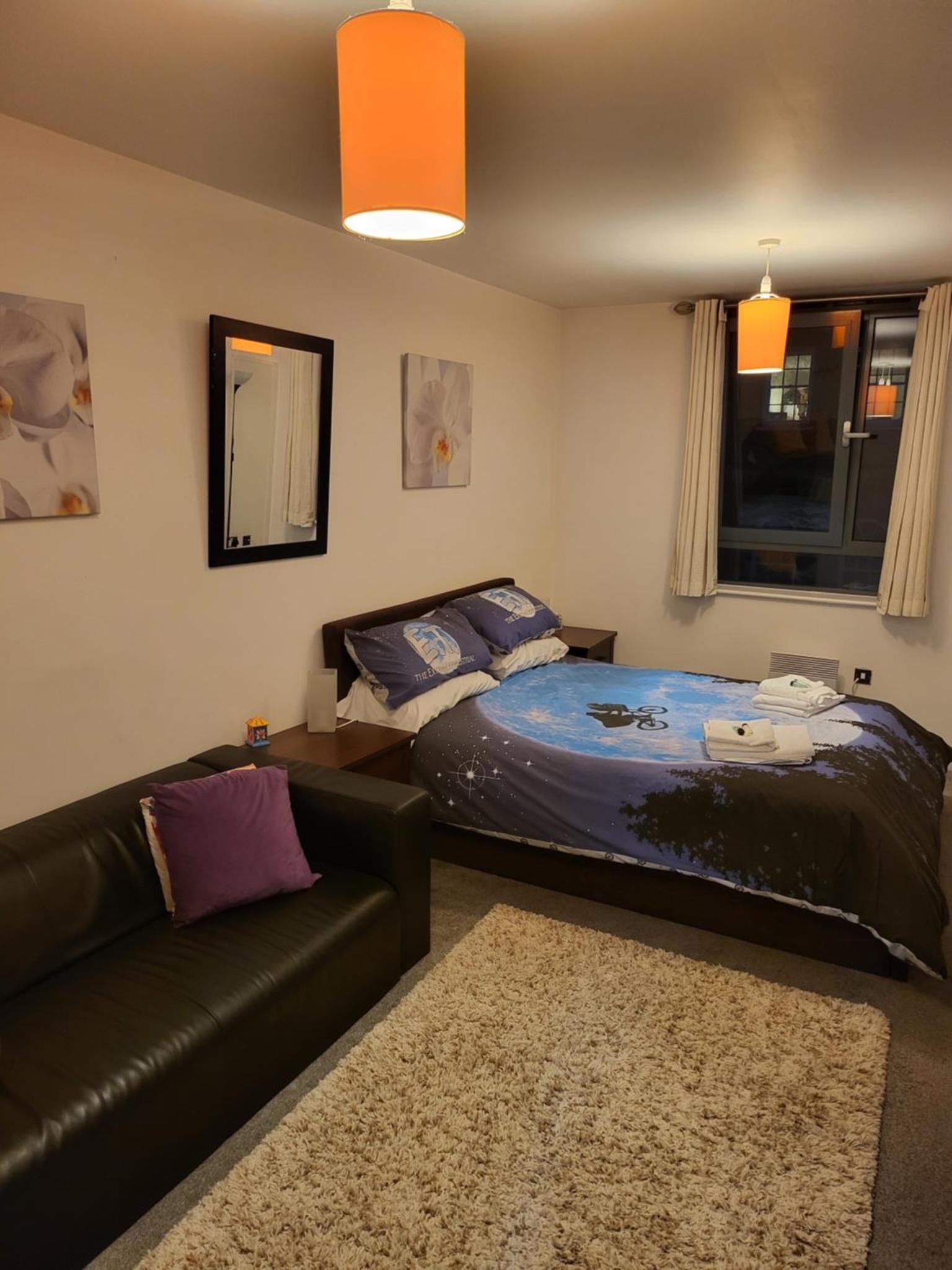a living room with a bed and a couch at WALKING TO TOWER BRIDGE in London