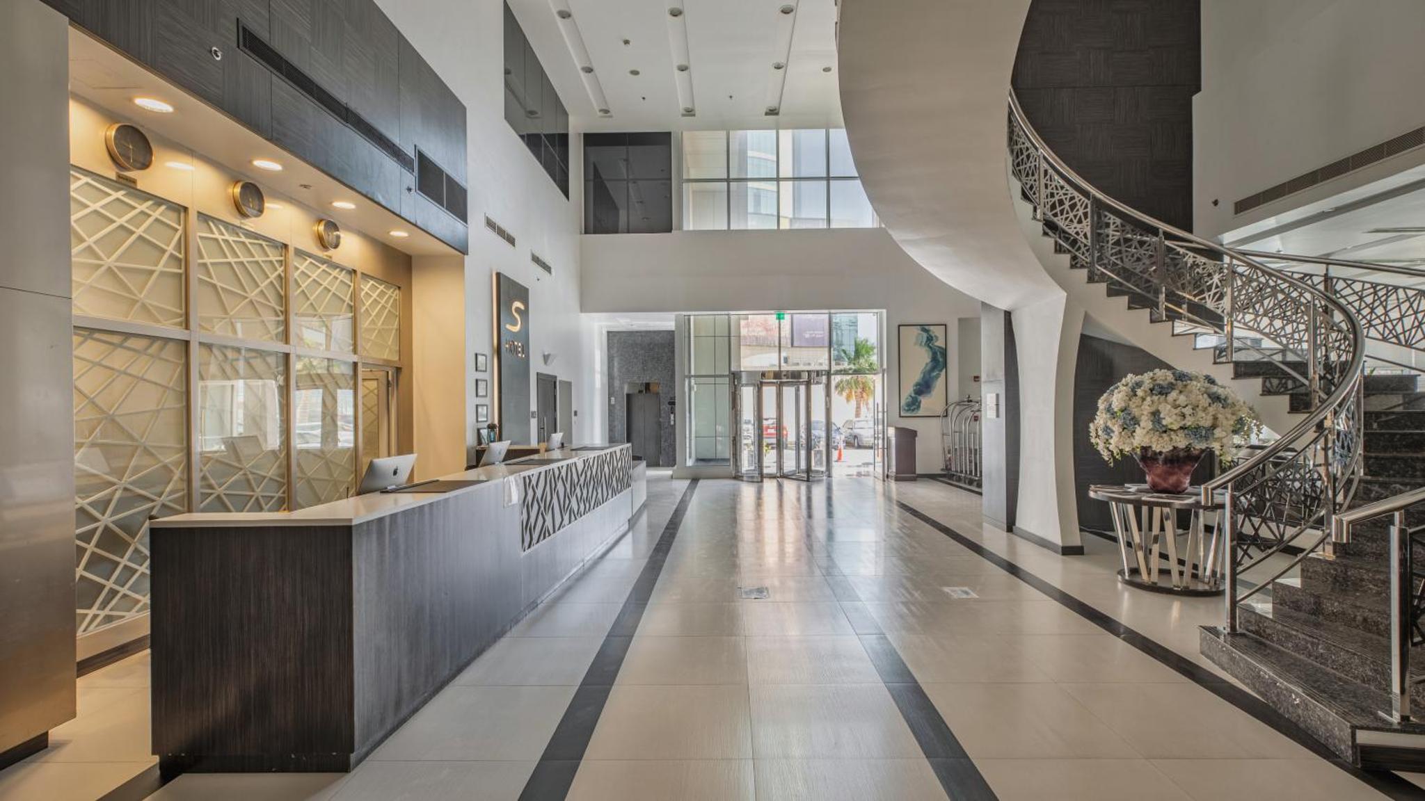 a hallway of a building with stairs and a lobby at S Hotel Bahrain in Manama +82 photos