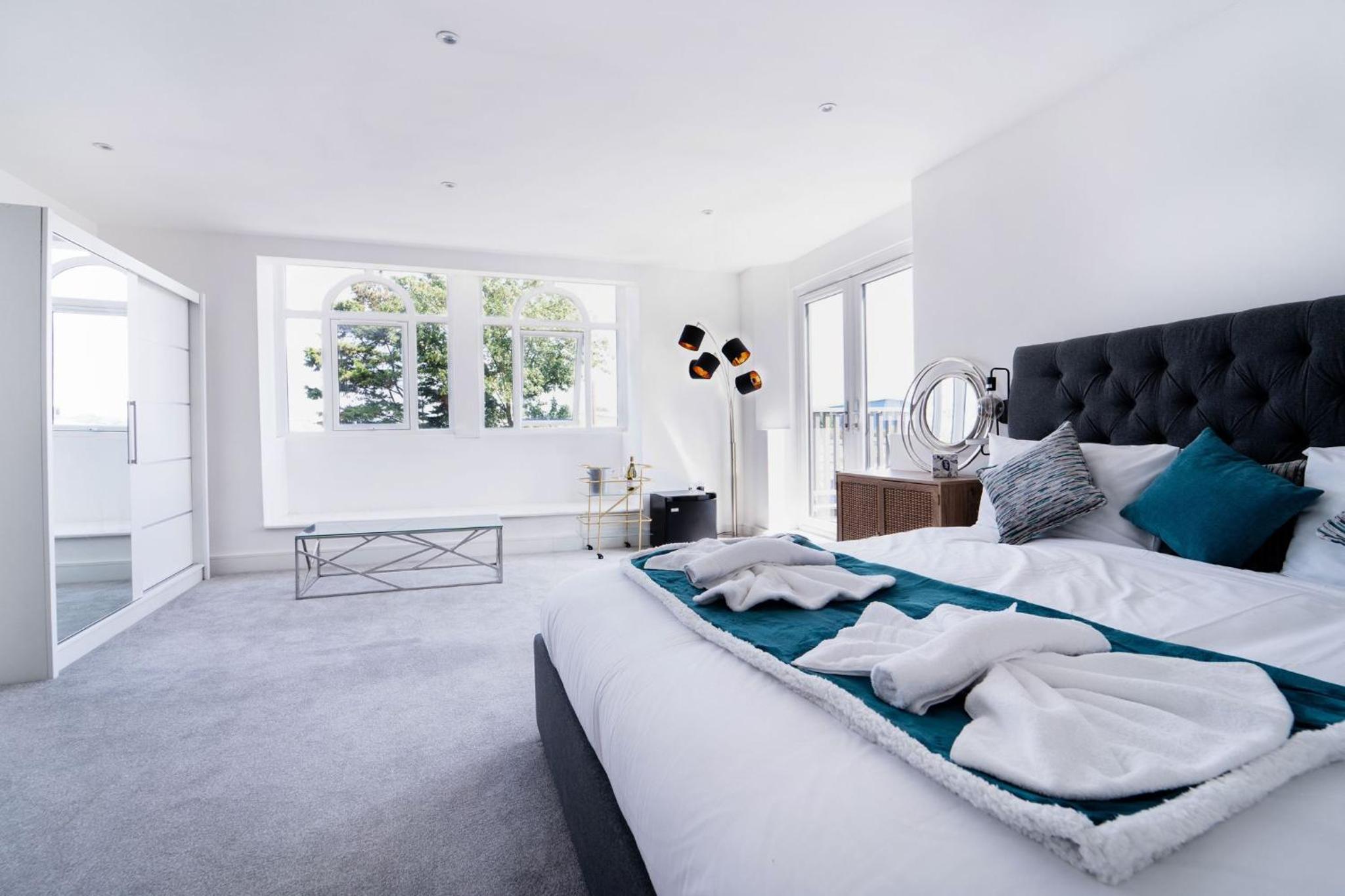 a bedroom with a large white bed with towels on it at Woodman Pub in London